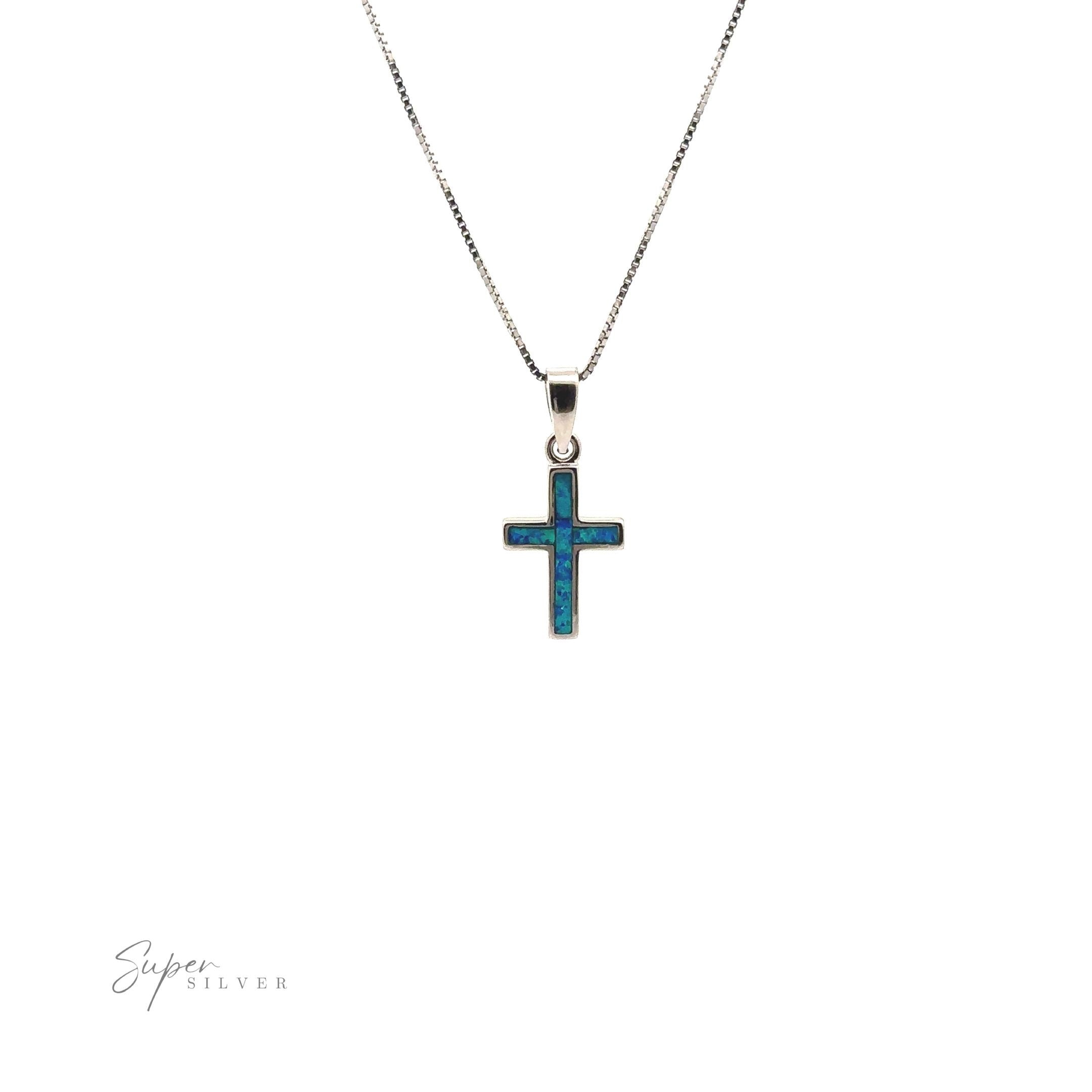 Lab-Created Opal Cross Pendants, crafted from sterling silver, showcase a minimalist design with a striking blue hue and are elegantly presented on a white background.