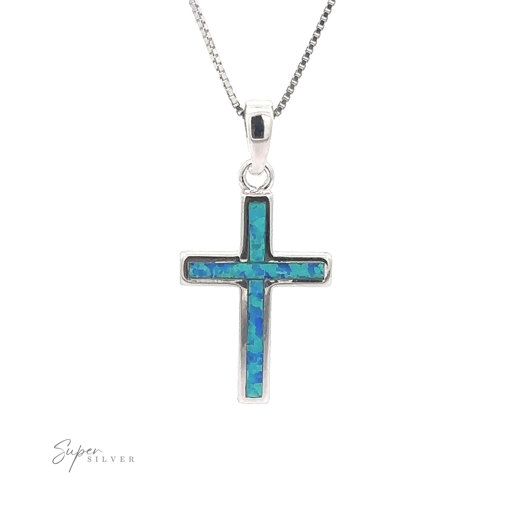 Crafted from sterling silver, the Lab-Created Opal Cross Pendants feature a minimalist design embellished with a beautiful blue-green mosaic inlay, offering an elegant touch when worn on its delicate chain.