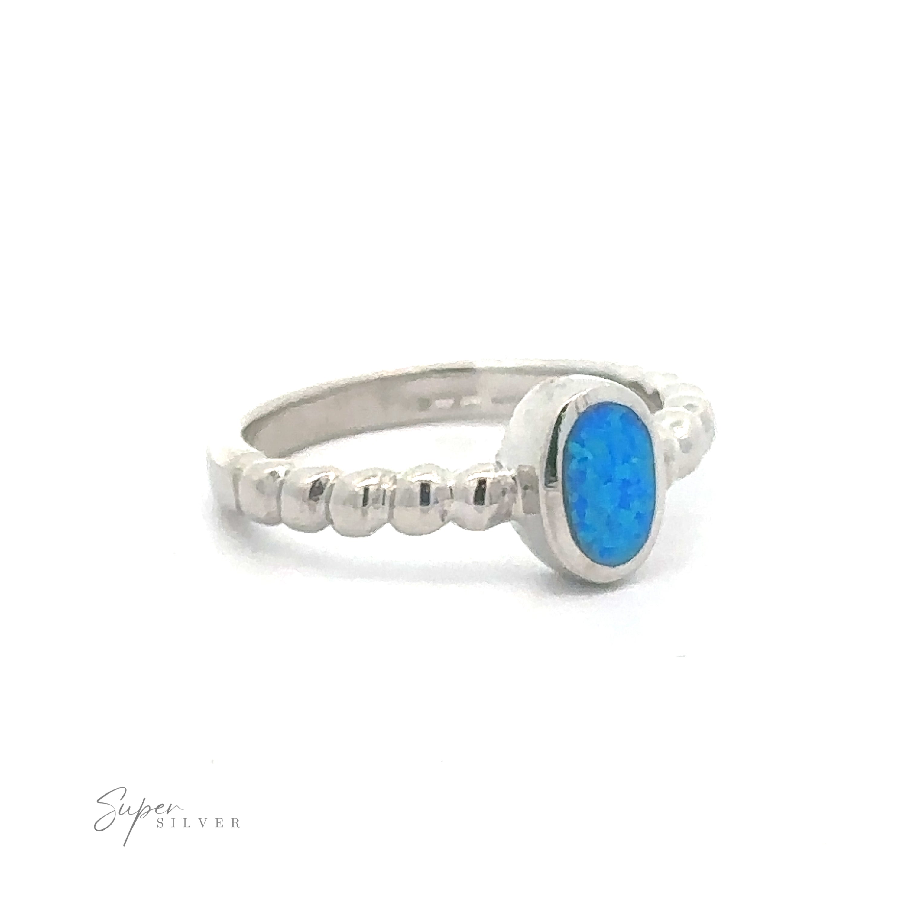 Sterling Silver ring with a blue oval Oval Lab Opal set in a simple bezel setting on a textured Beaded Band.
