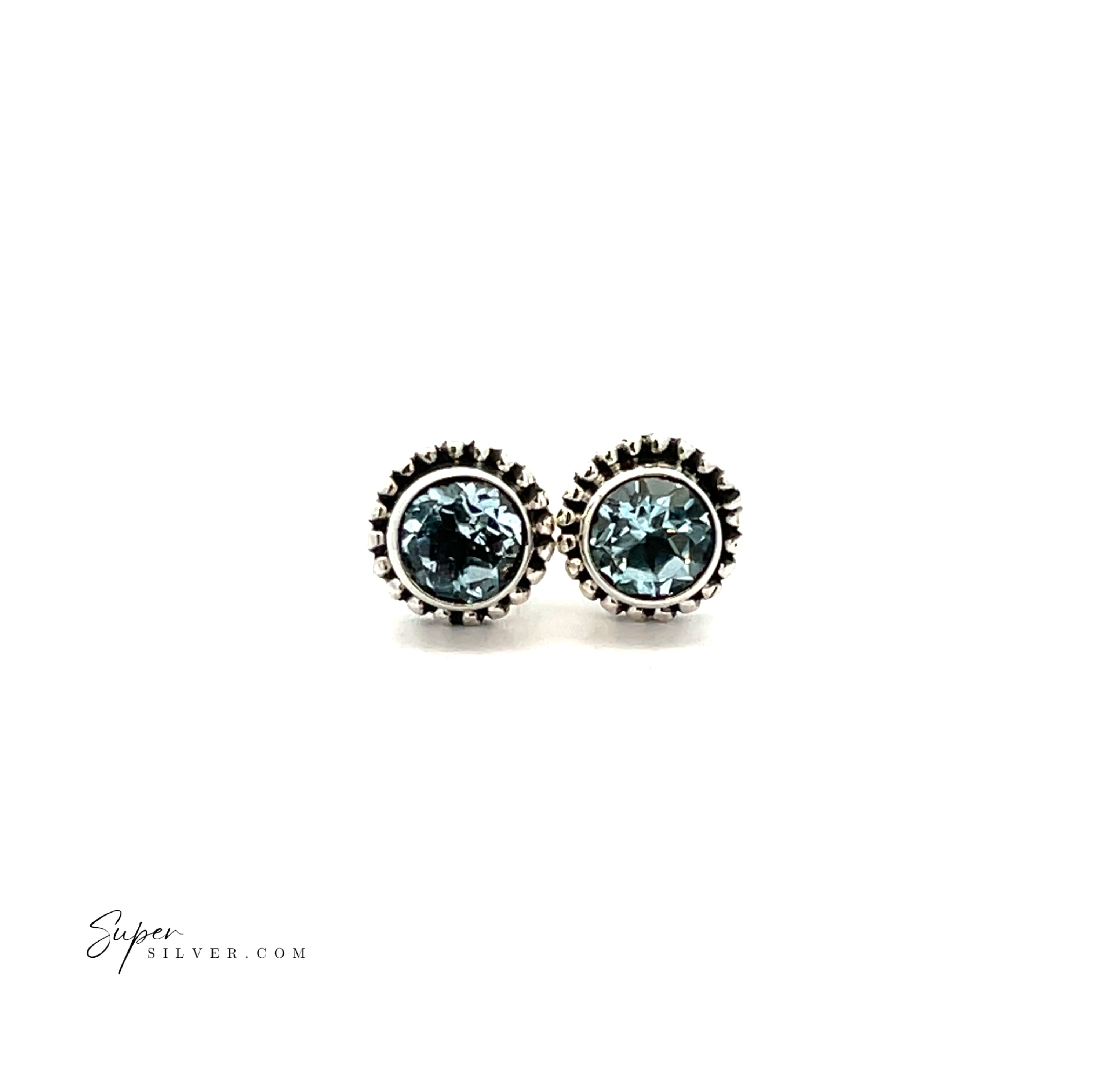 The Beaded Round Faceted Gemstone Studs are sterling silver earrings with blue gemstones and a beaded edge, shown on a white background.