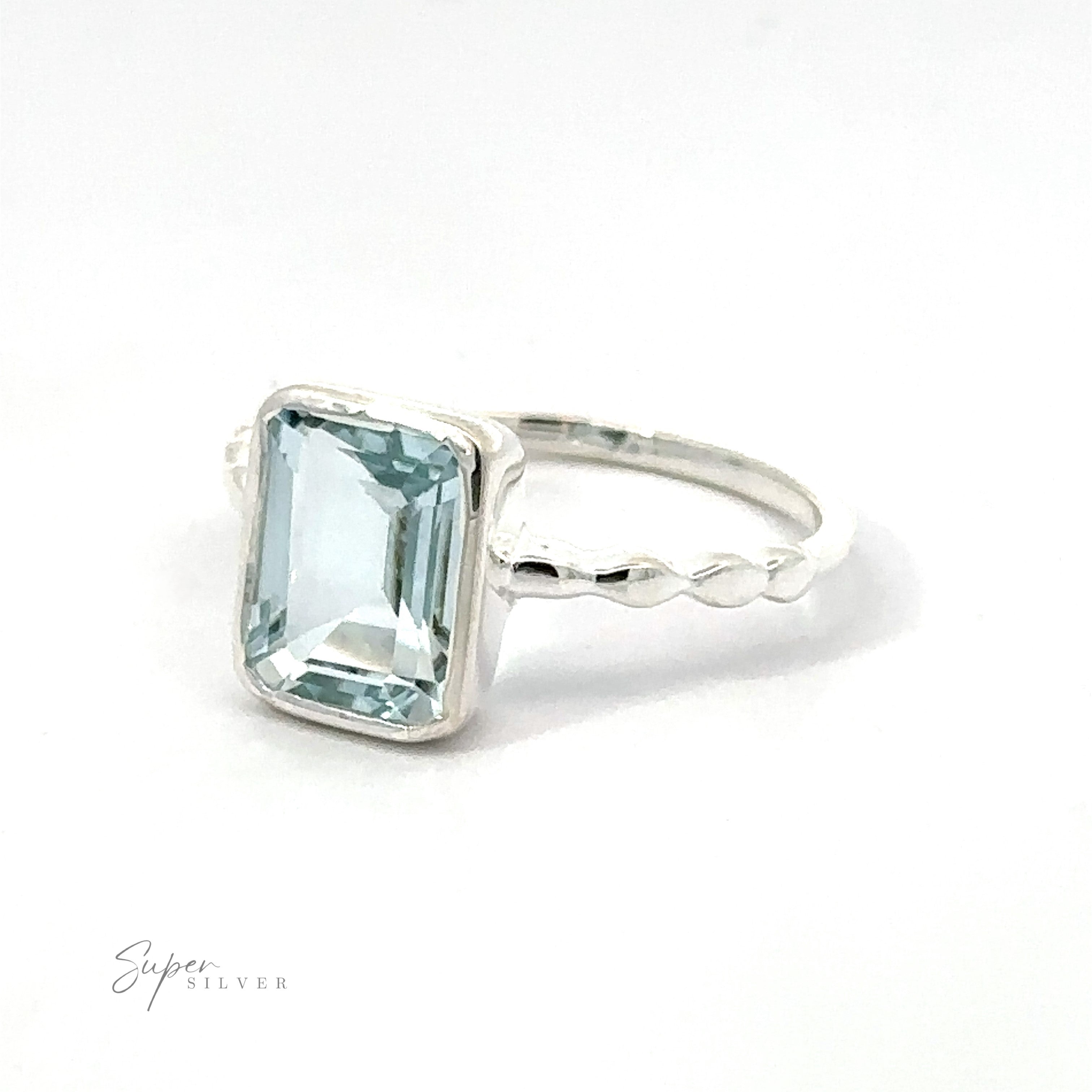 Rectangle Gemstone Ring with Beaded Band with a large rectangular aquamarine gemstone set in a .925 sterling silver band, displayed against a white background.