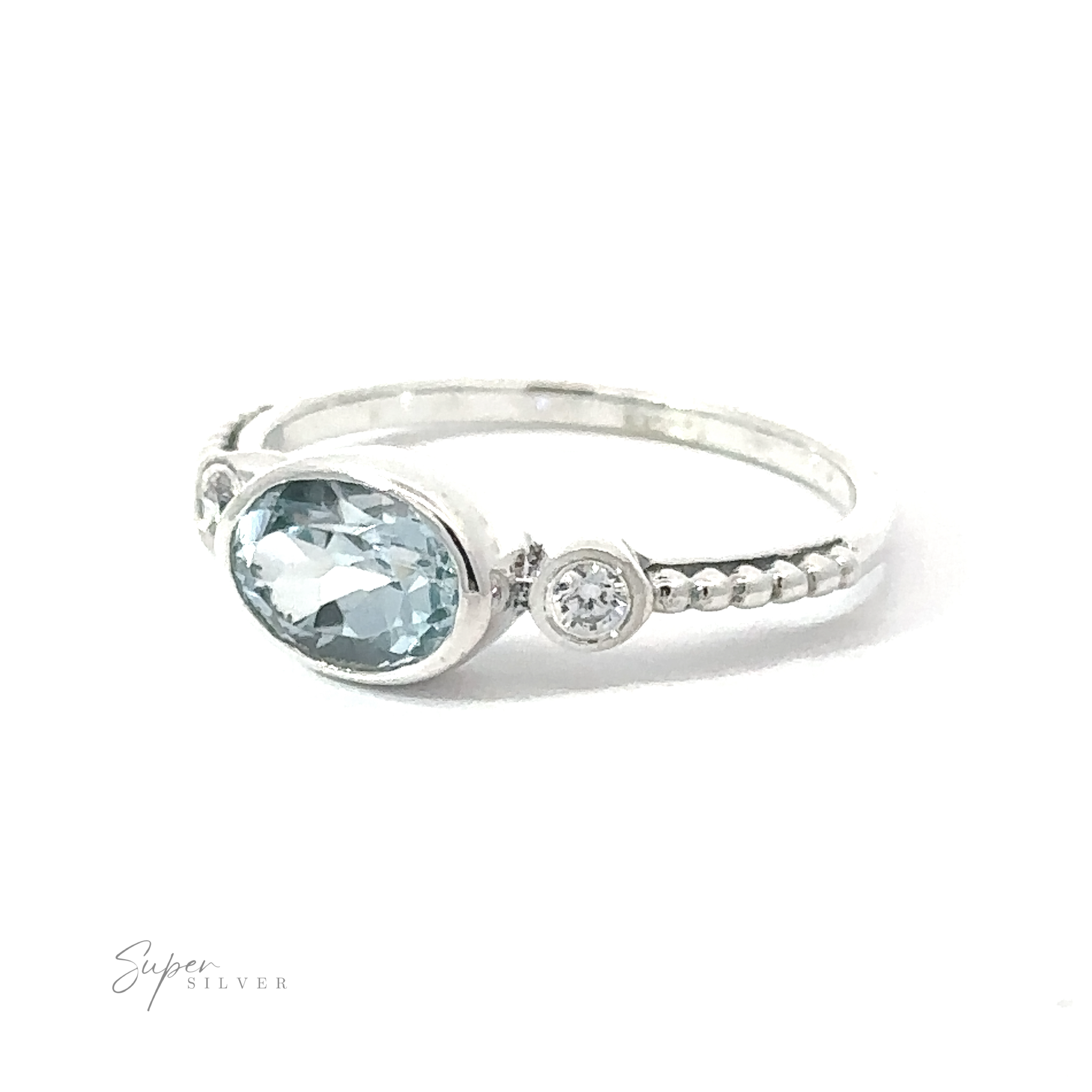 Horizontal Oval Gemstone Ring with Beaded Band with an oval aquamarine gemstone flanked by a smaller round diamond, handcrafted and displayed on a white background.
