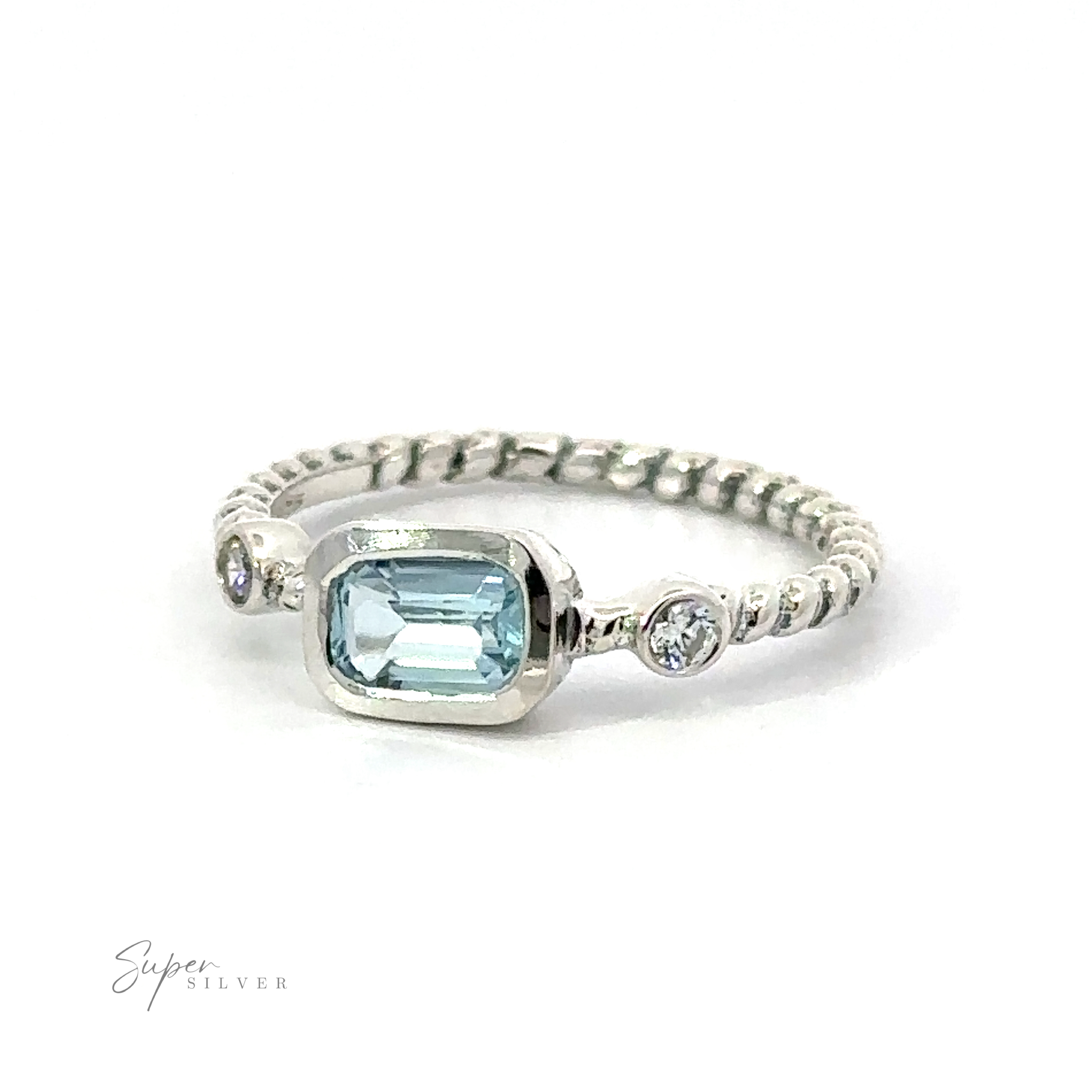 Rectangle Gemstone Ring with Twisted Band with a central aquamarine stone flanked by two smaller diamonds on a white background.