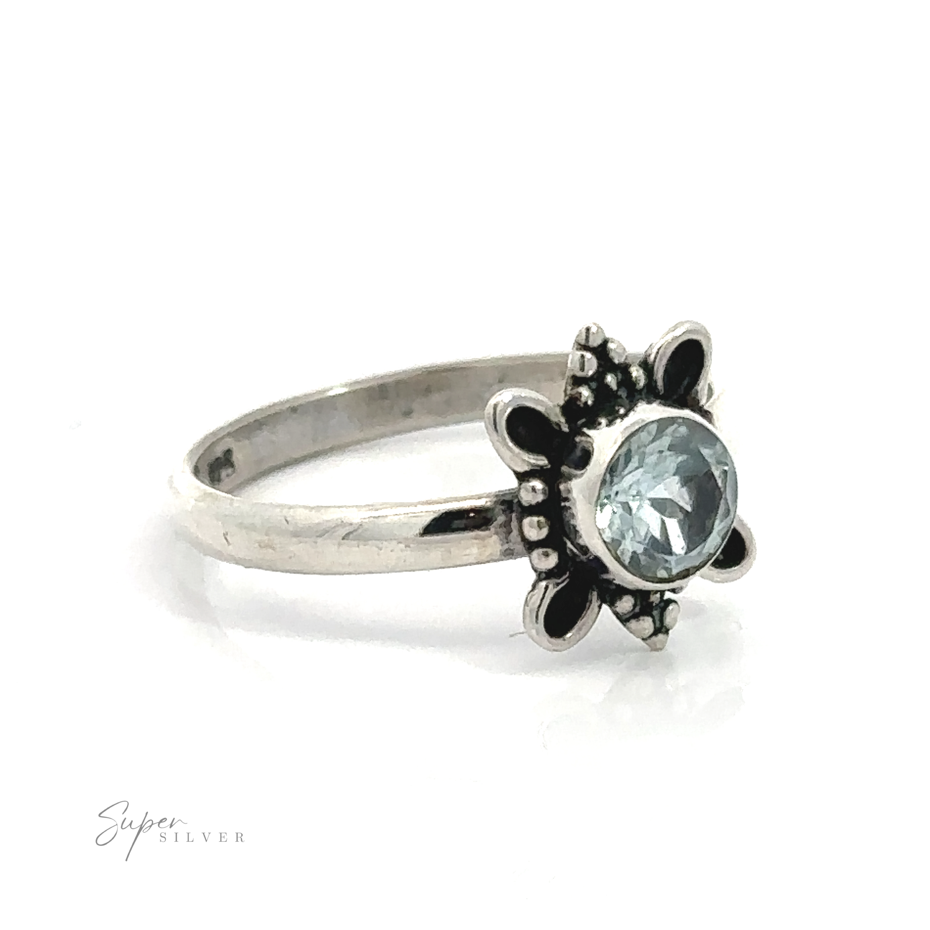 A sterling silver ring with a flowers design and a central Round Faceted Gemstone Ring with Ball and Loop Design.