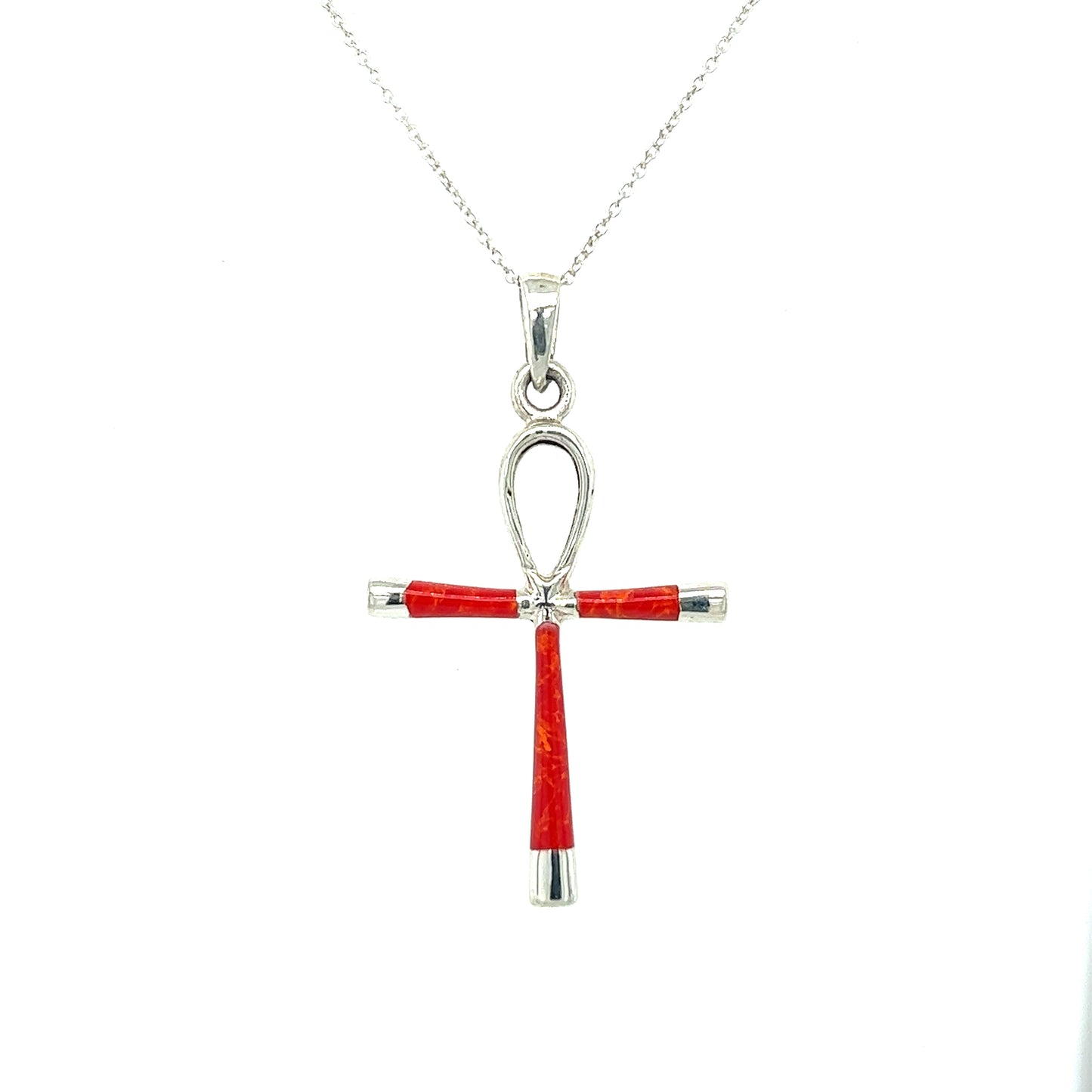 
                  
                    A statement piece, this Super Silver Inlay Stone Ankh Pendant combines the symbolism of ancient Egypt with the vibrant red coral and sleek sterling silver design.
                  
                