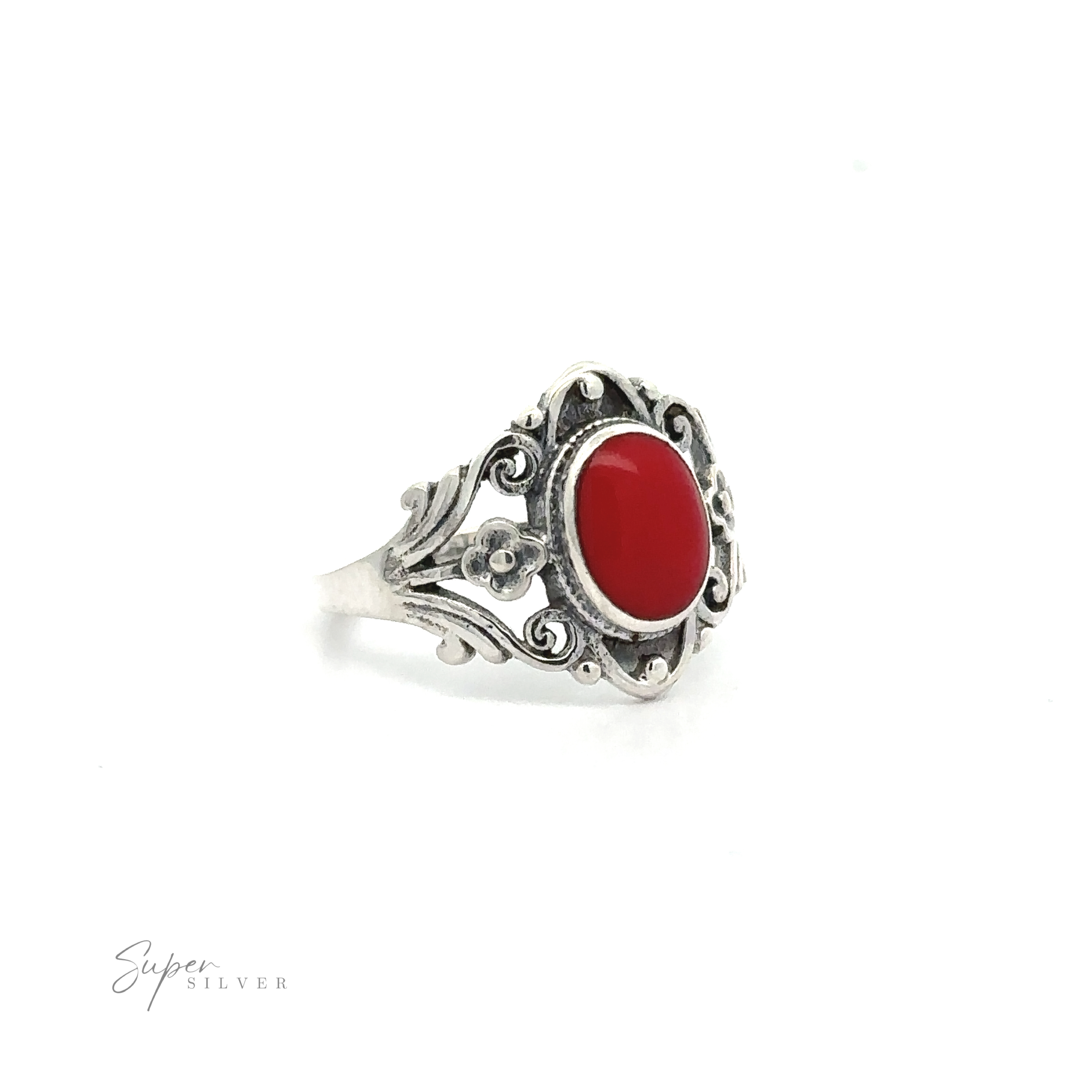 A Floral Filigree Inlay Stone Ring with a red stone.