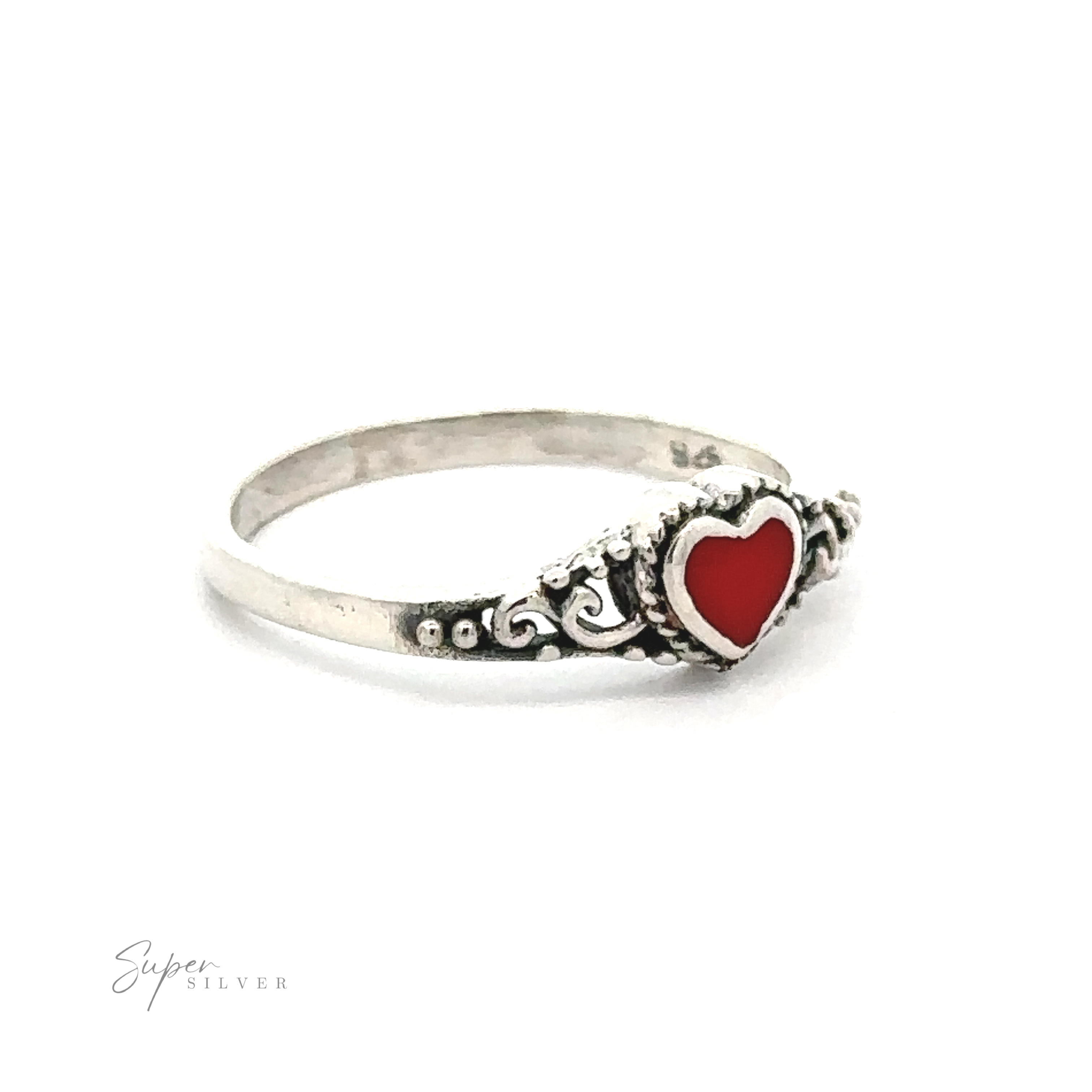 A Dainty Heart Filigree Ring with Inlaid Stones featuring a red stone heart on it.