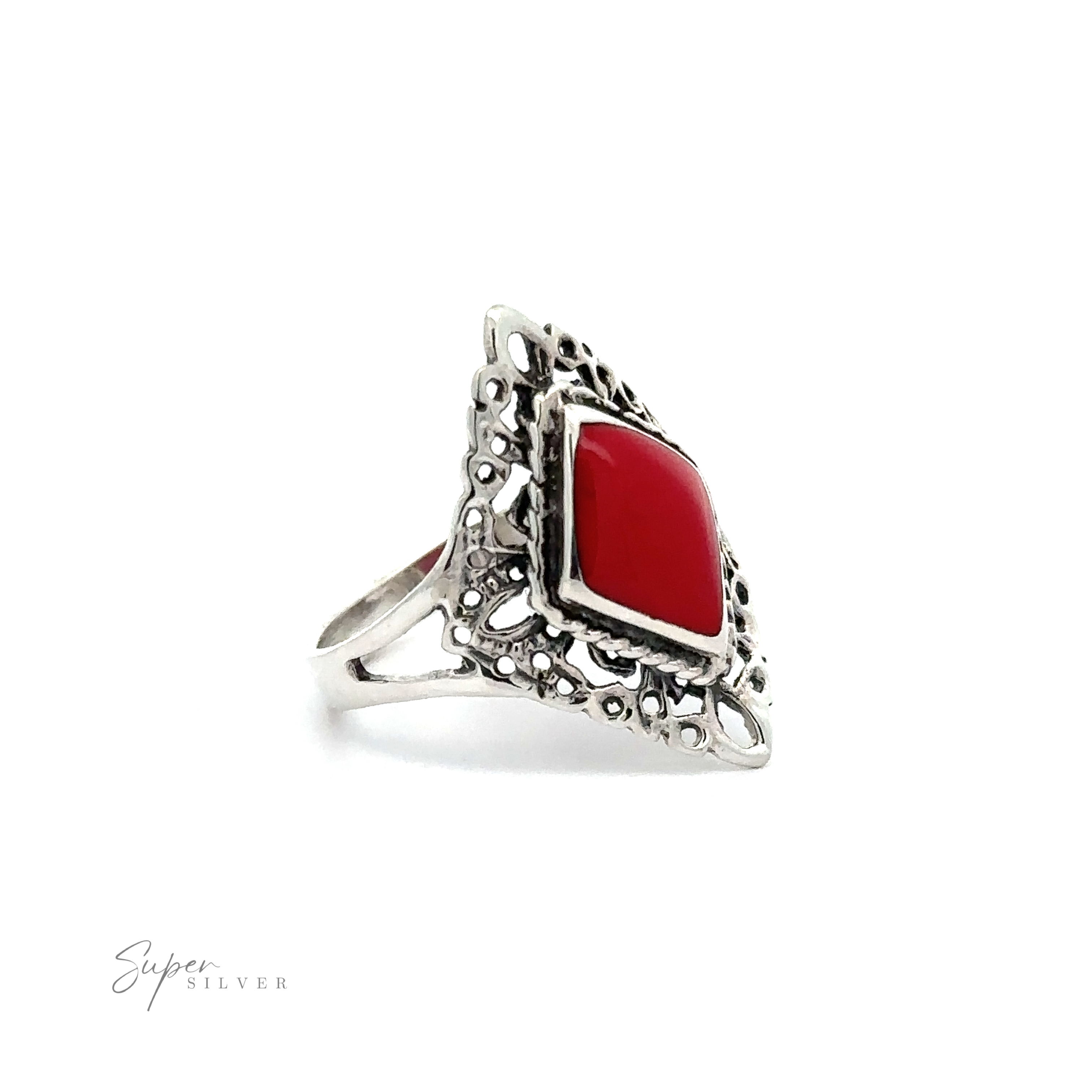 A Diamond Shaped Filigree Ring with Inlaid Stones with a silver band adorned with lacy filigree, featuring a low profile red stone.