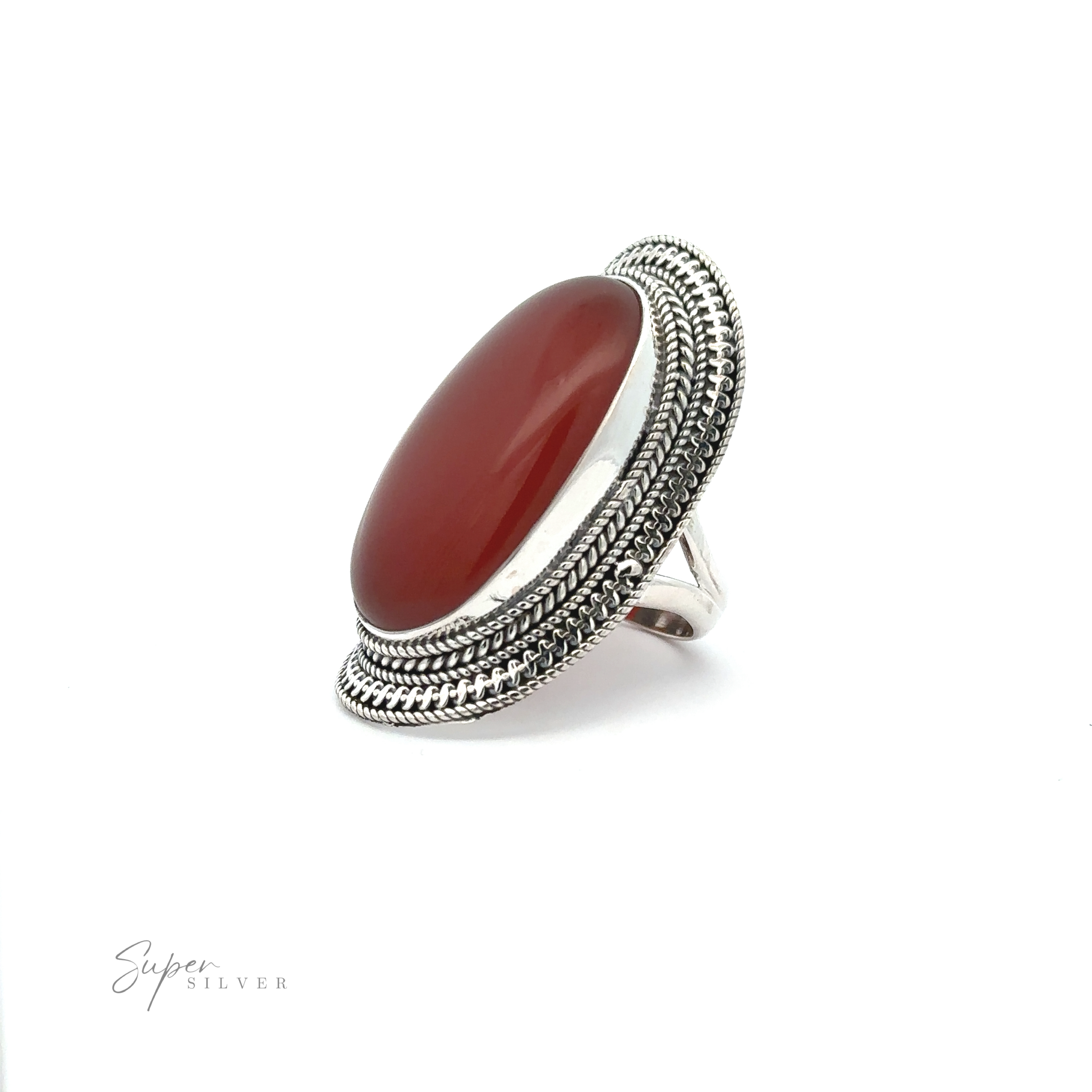 A Large Oval Shield Gemstone Ring featuring an oval red gemstone set in an intricate, textured band with a bohemian flair is displayed against a white background. Text on the image reads, "Super Silver.