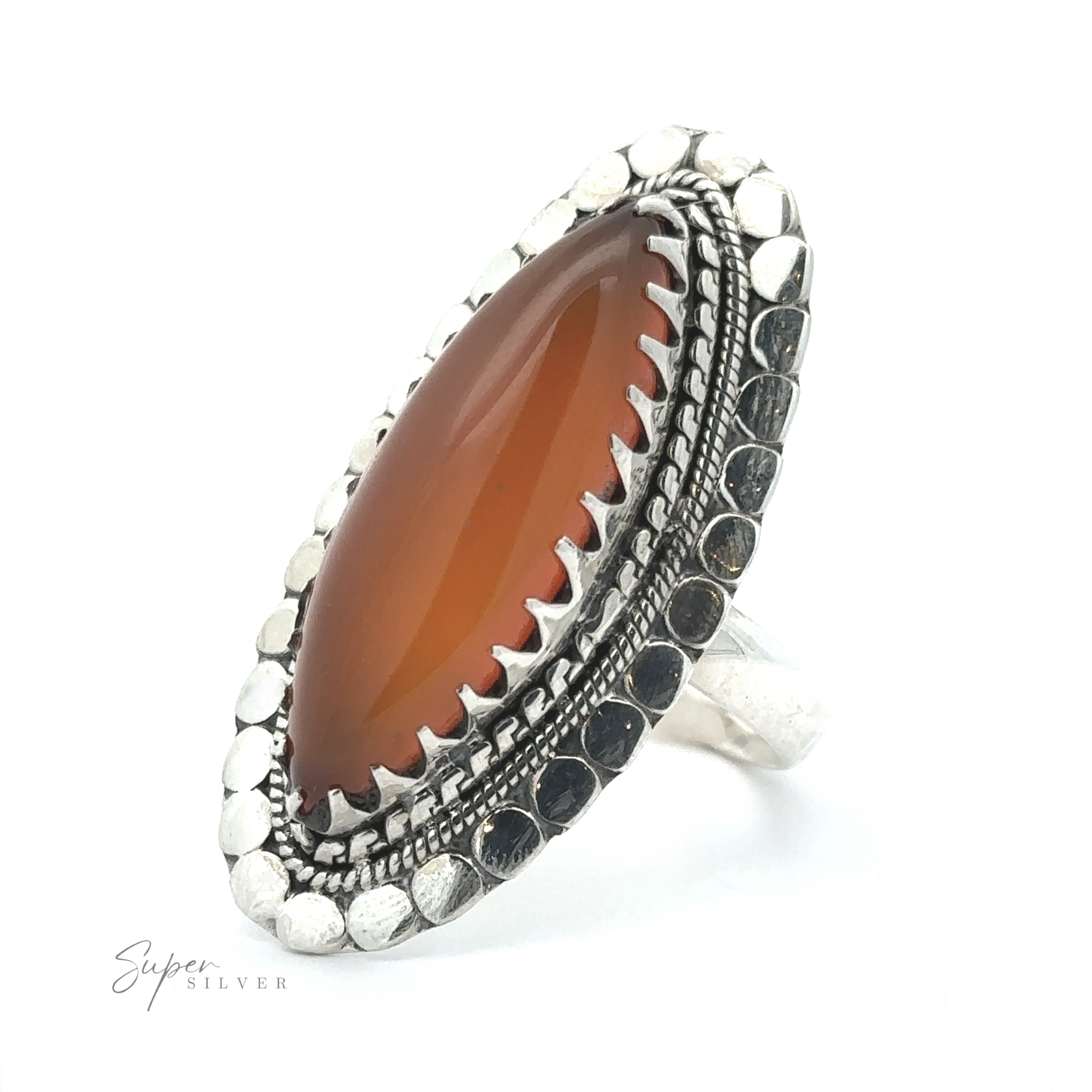 A Bohemian jewelry piece, the Statement Marquise Shaped Gemstone Ring features a large oval, reddish-brown stone in the center, surrounded by intricate metalwork and a border of small metallic beads.