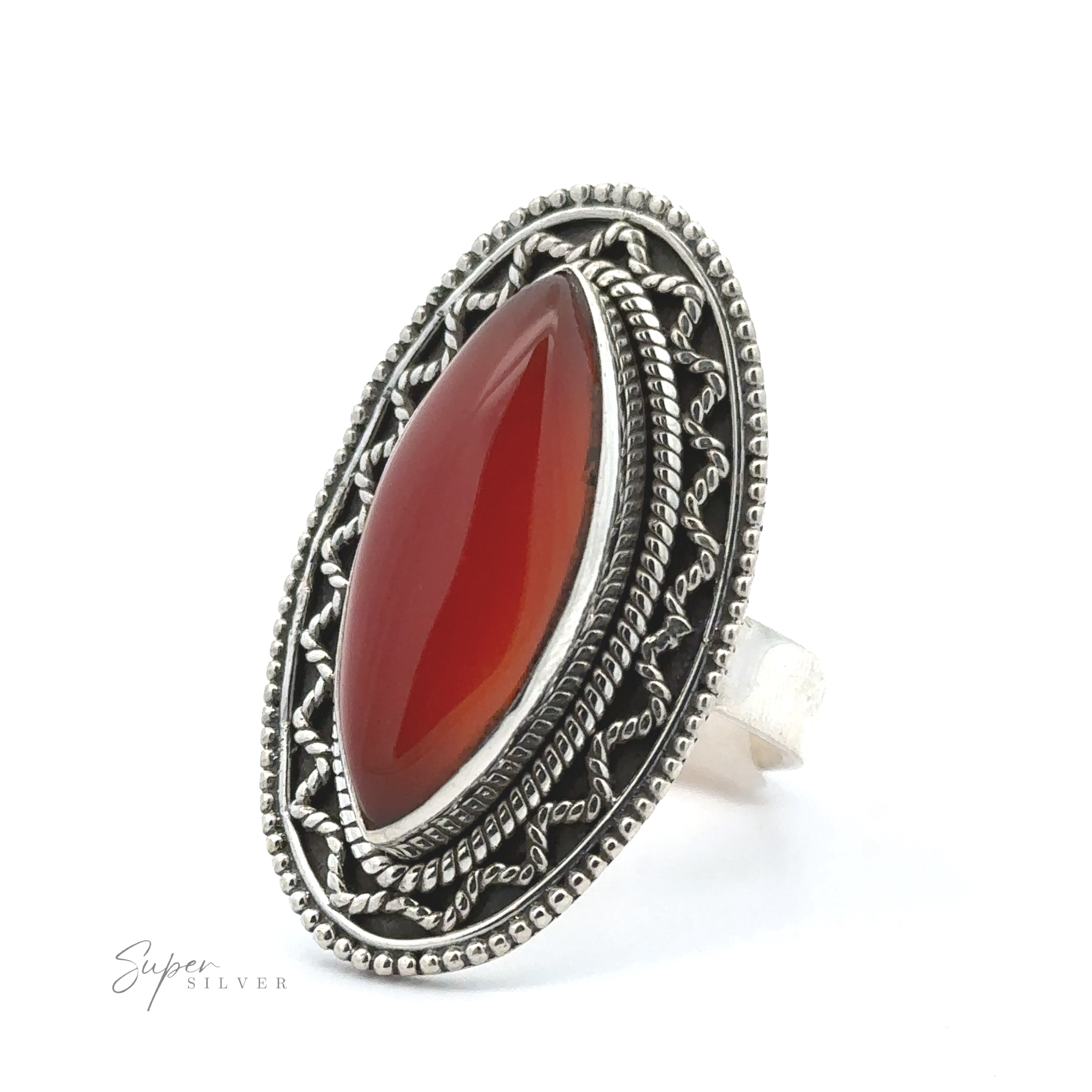 A Marquise Shaped Gemstone Ring With Vintage Shield Border featuring an oval-shaped red gemstone set in an ornate, intricately designed band with a bohemian twist.