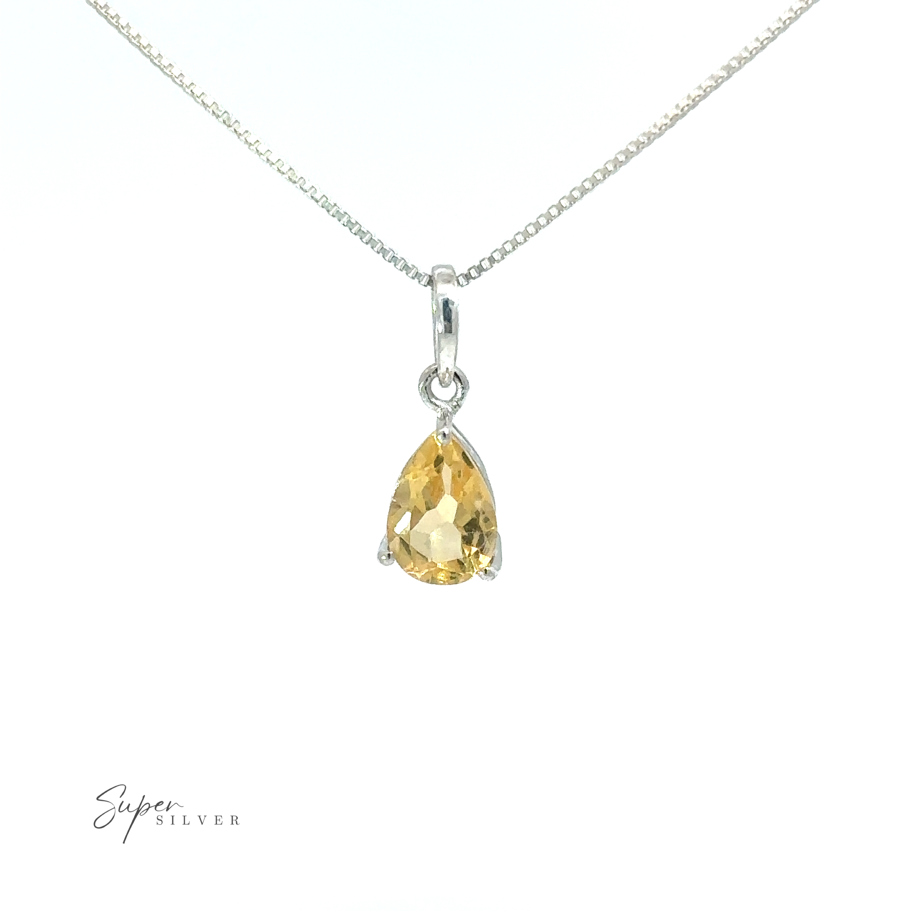 A minimalist style Dainty Faceted Gemstone Pendant on a silver chain shaped like a tiny teardrop gemstone.