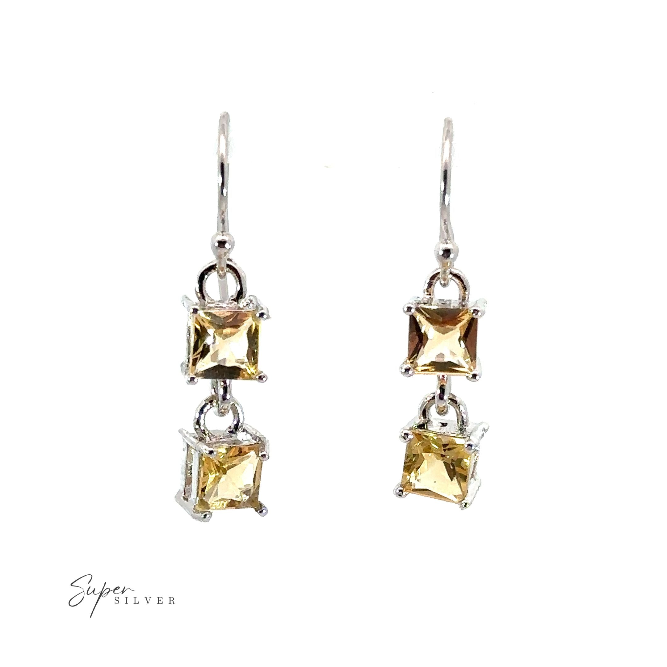 A pair of Elegant Faceted Gemstone Jewelry Set adorned with two citrine gemstones, exuding sophistication.