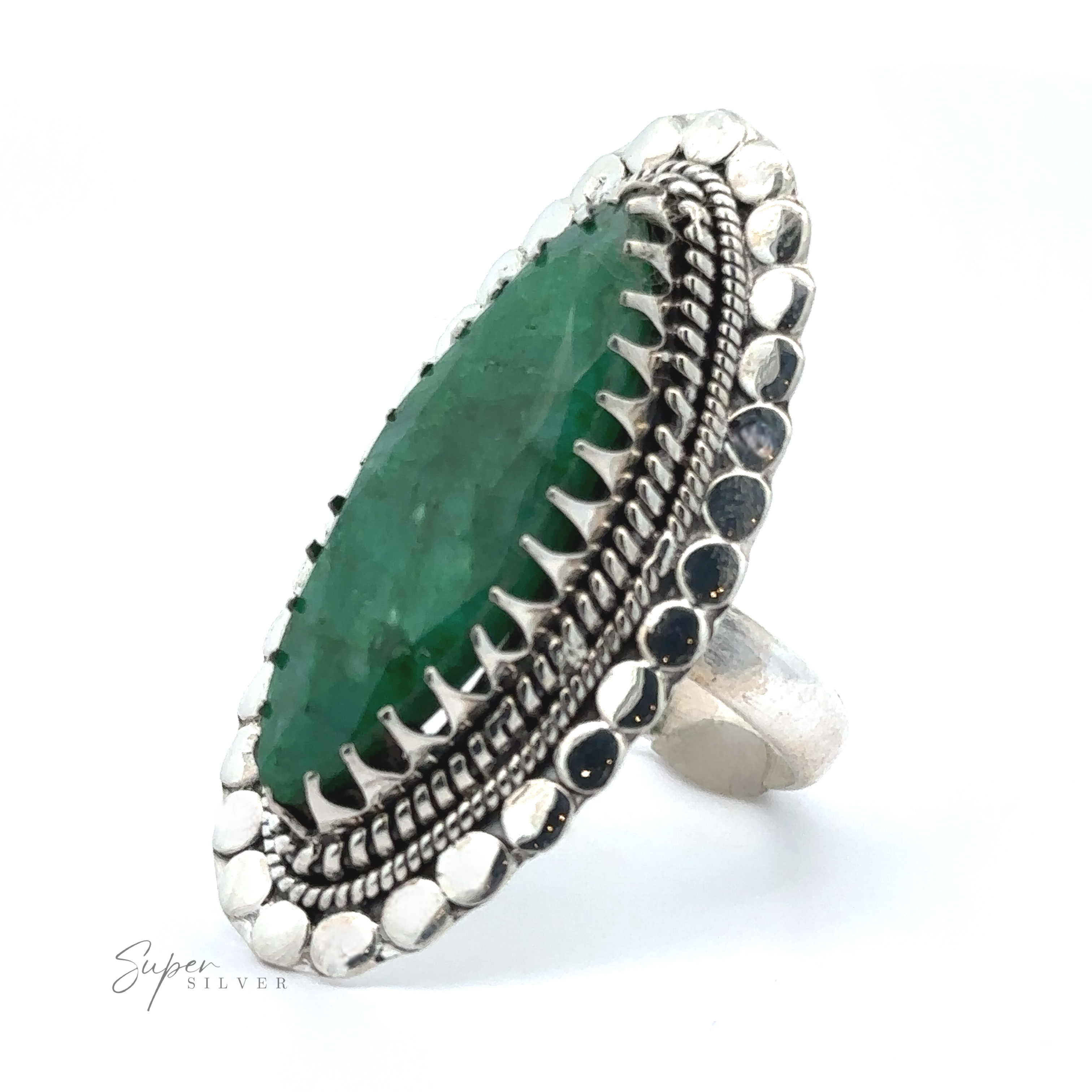 A striking Statement Marquise Shaped Gemstone Ring with an oval-shaped green stone surrounded by intricate metalwork and a textured band, epitomizing bohemian jewelry, displayed on a white background.