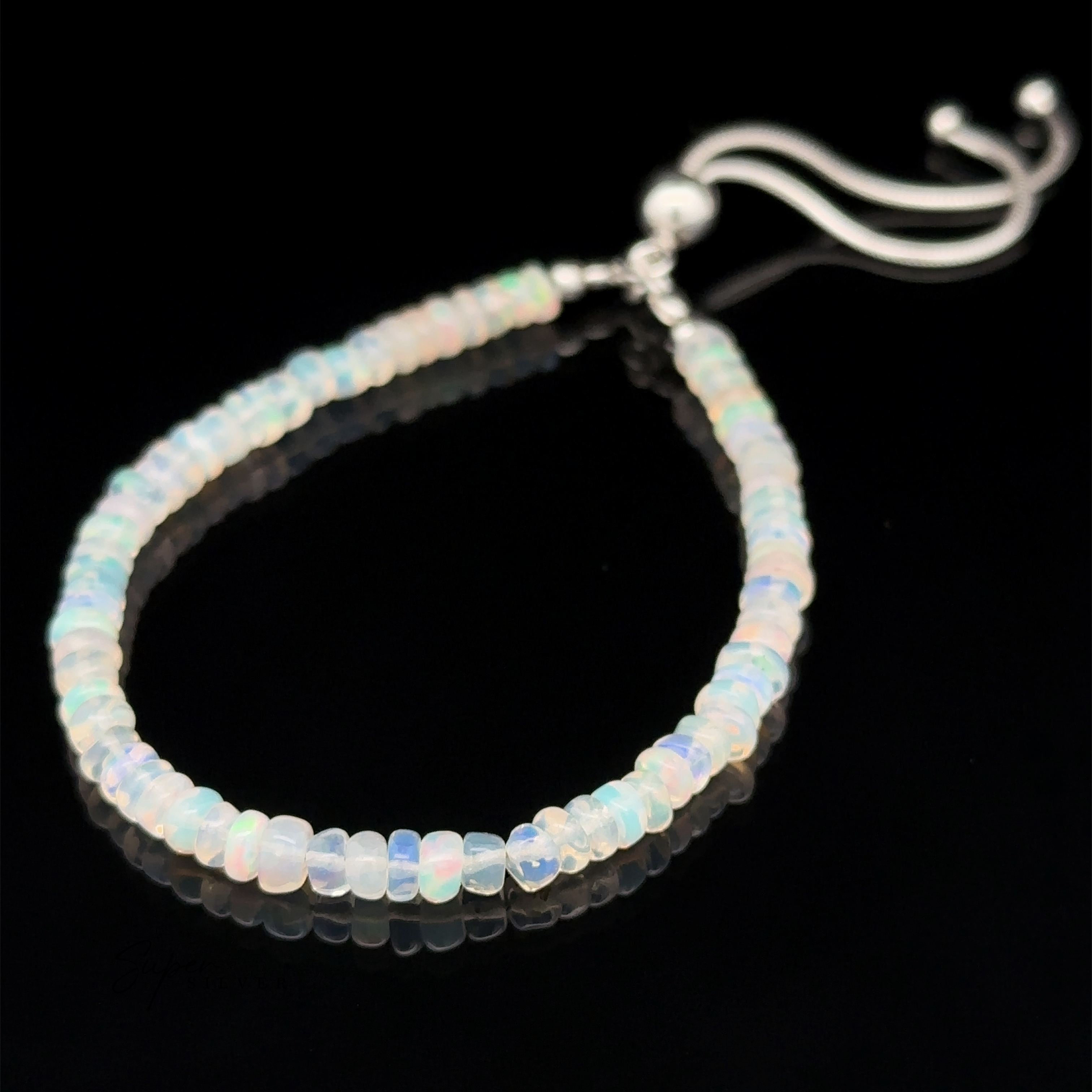 An Ethiopian Opal Beaded Bracelet featuring an adjustable silver clasp, showcased against a black background.
