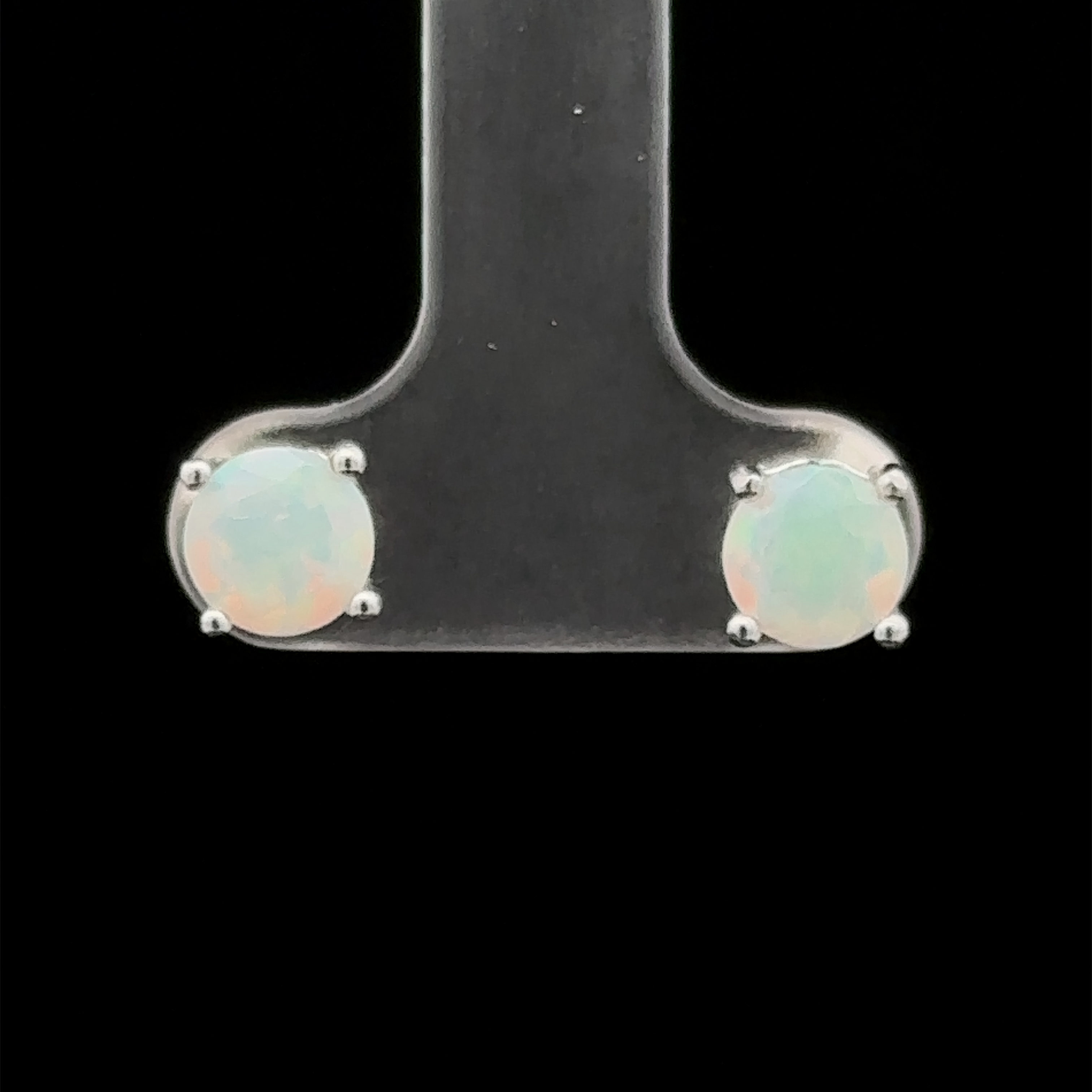 Round Ethiopian Opal Studs featuring 6mm opals set in sterling silver prongs, shown against a black background.