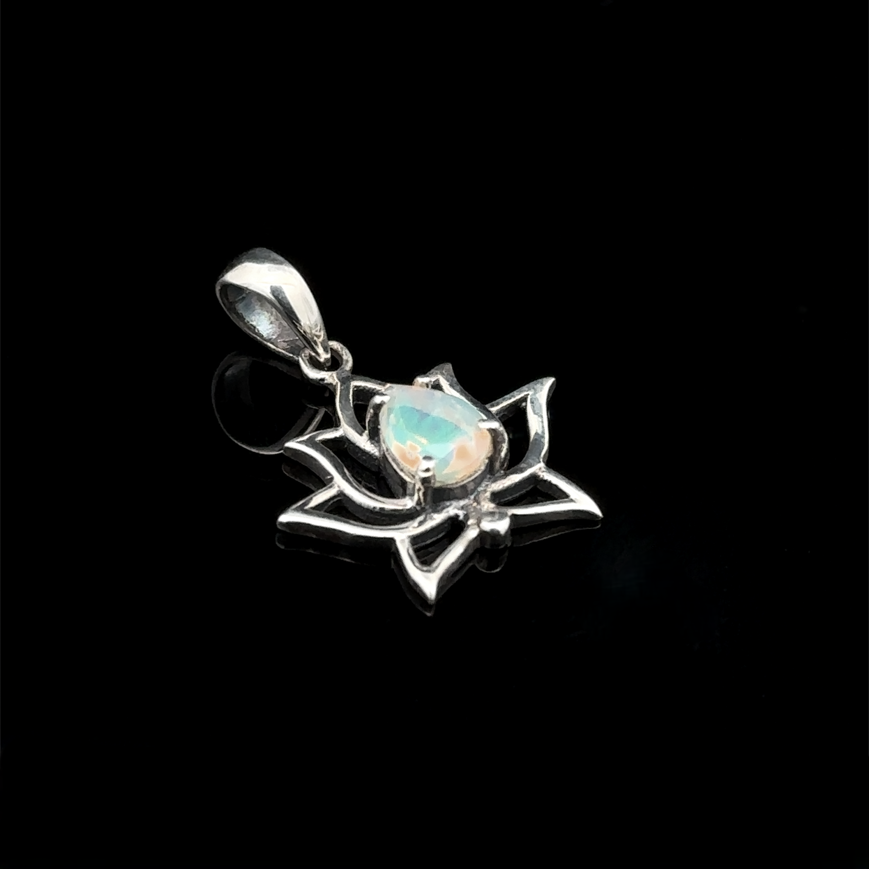 The Ethiopian Opal Lotus Pendant showcases a polished Ethiopian opal gemstone centrally set in a sterling silver lotus flower design, highlighted against a black background.