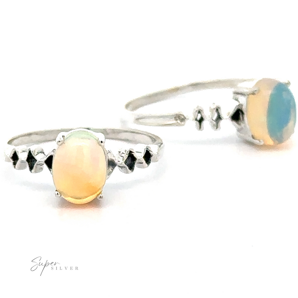 Two Pronged Ethiopian Opal with Diamond Pattern rings with sterling silver bands and small black accent stones, displayed against a white background.