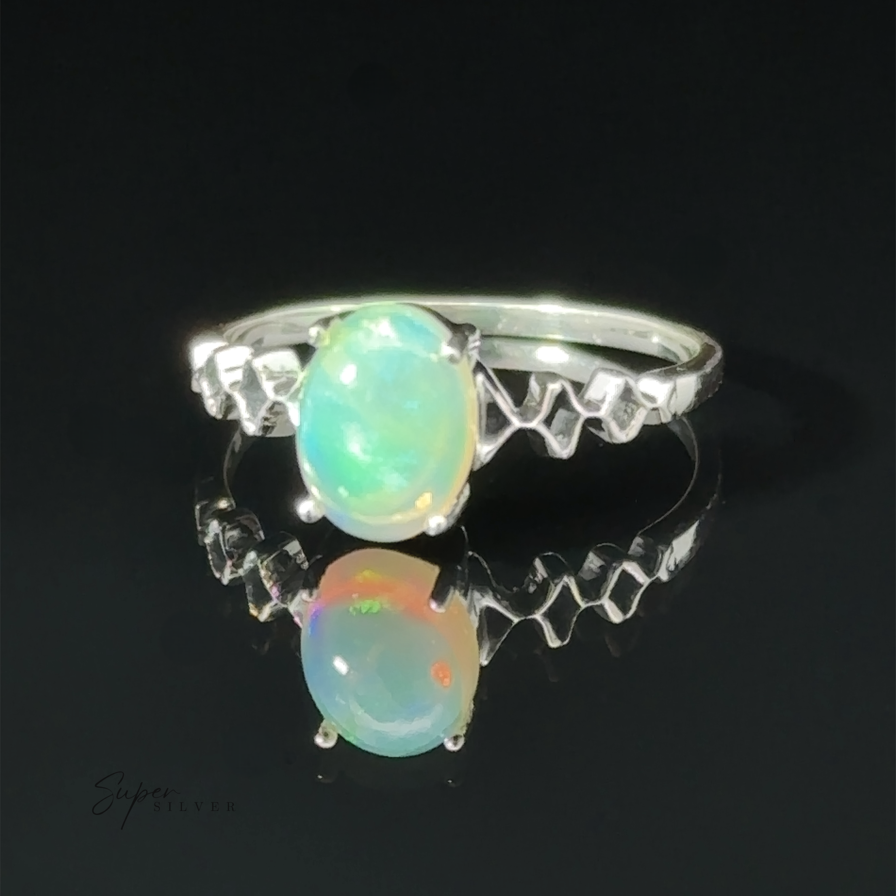 Pronged Ethiopian Opal with Diamond Pattern ring displayed against a dark background with a reflection underneath.