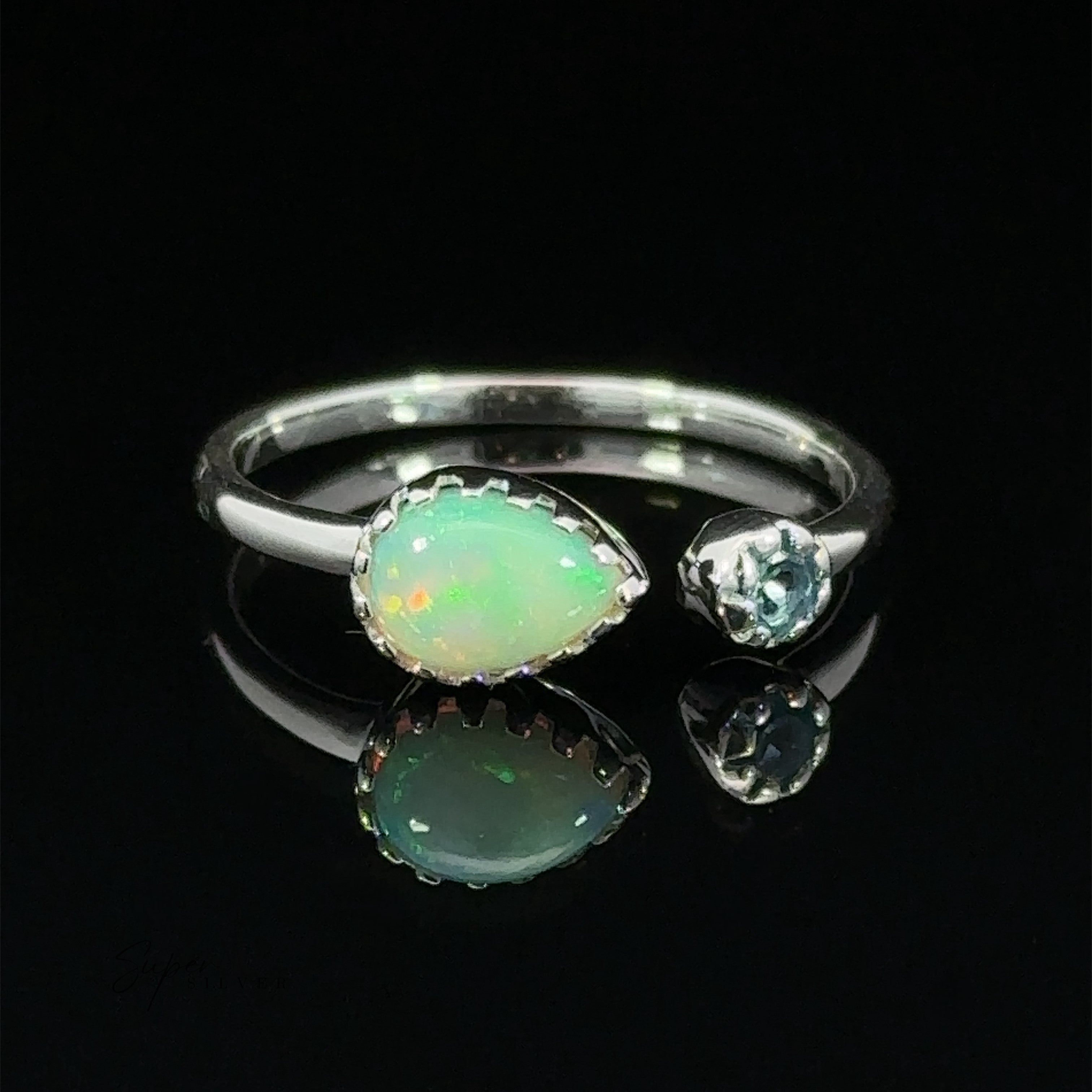 Dainty Adjustable Gemstone Ring with Two Stones with a pear-shaped opal set alongside a small round diamond, displayed against a black background.