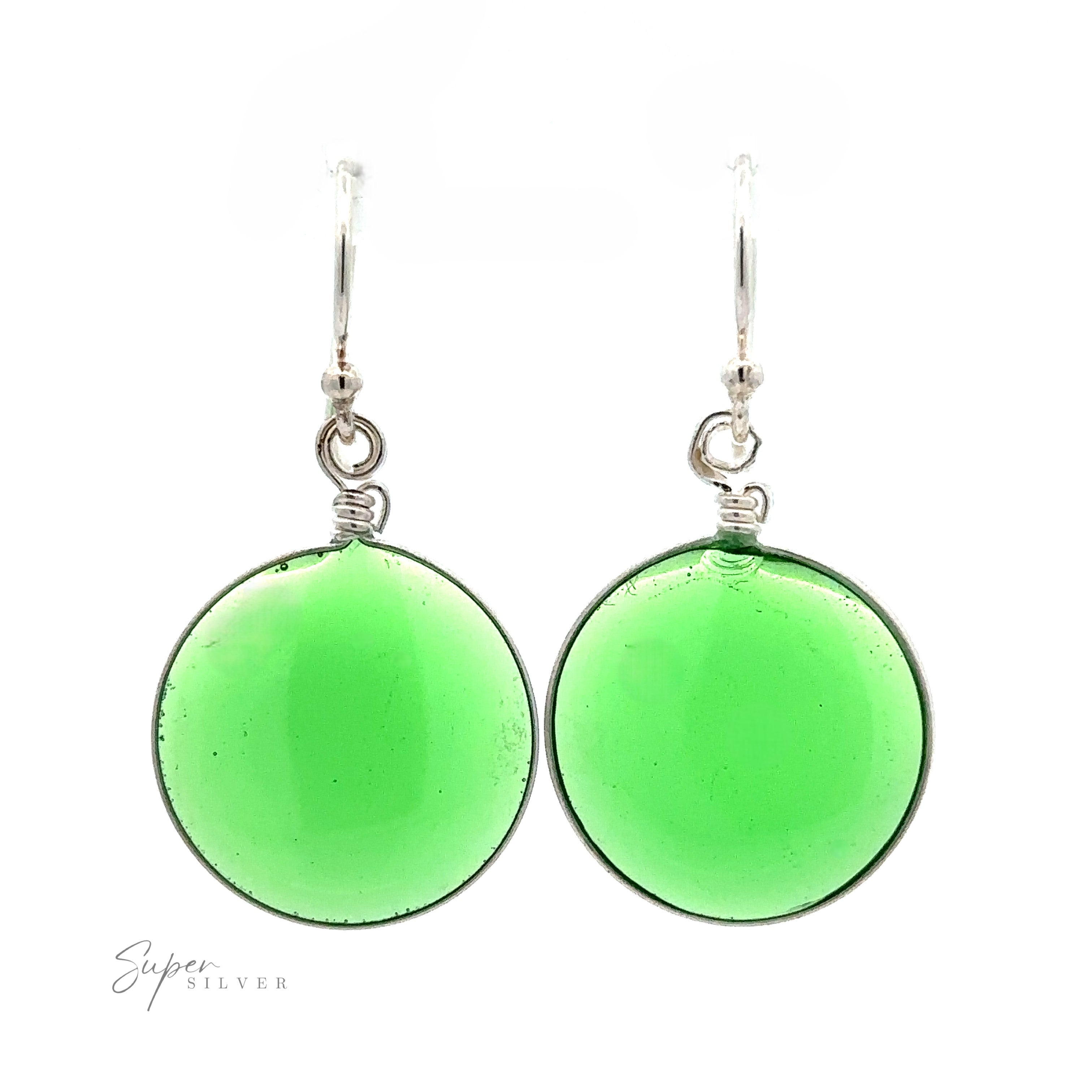A pair of simple yet elegant Round Glass Earrings featuring round, translucent green glass stones. Crafted with .925 Sterling Silver, the looped hooks add a refined touch against the white background.