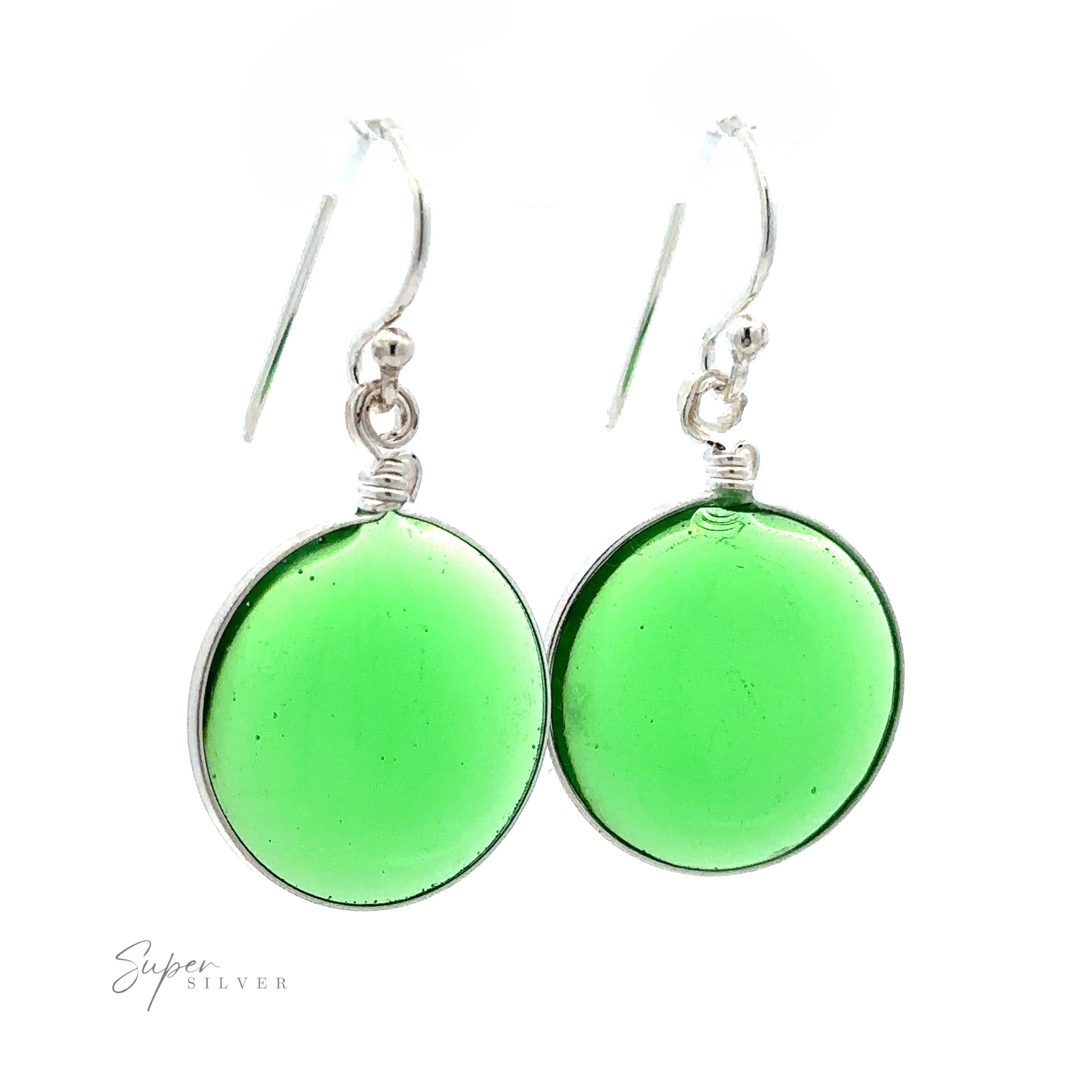 A pair of Round Glass Earrings featuring round, translucent green glass pendants. These glass earrings hang from hooks and boast a simple, minimalist design.