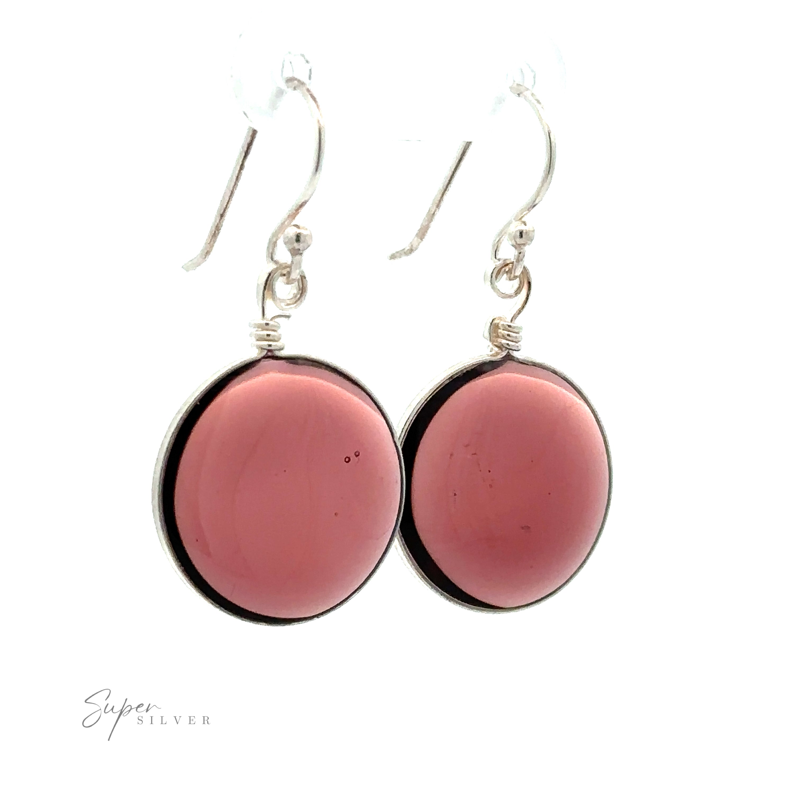 Close-up of a pair of silver hook earrings featuring large, round, pink stones in bezel settings, highlighting their .925 Sterling Silver composition with the text "Round Glass Earrings" in the bottom left corner.