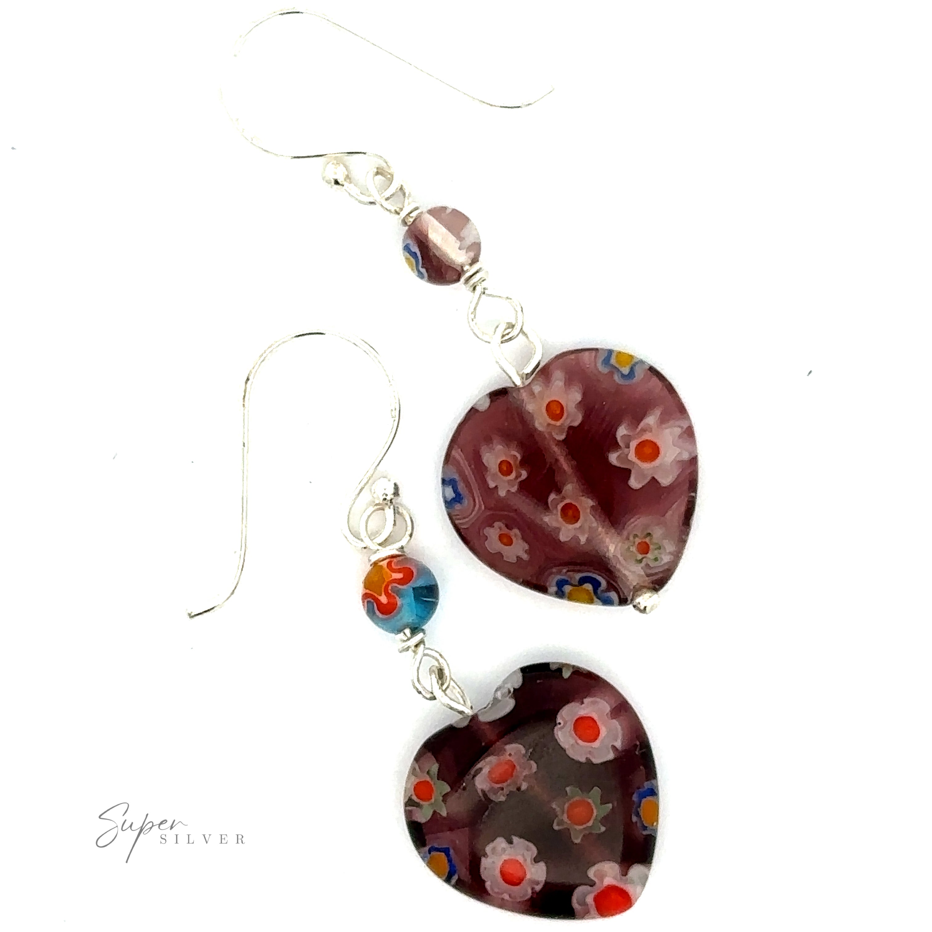A pair of Beaded Resin Floral Heart Earrings with red, white, blue, and yellow floral designs. The earrings, crafted from .925 Sterling Silver, feature wire hooks and a small wine-colored bead above each heart.