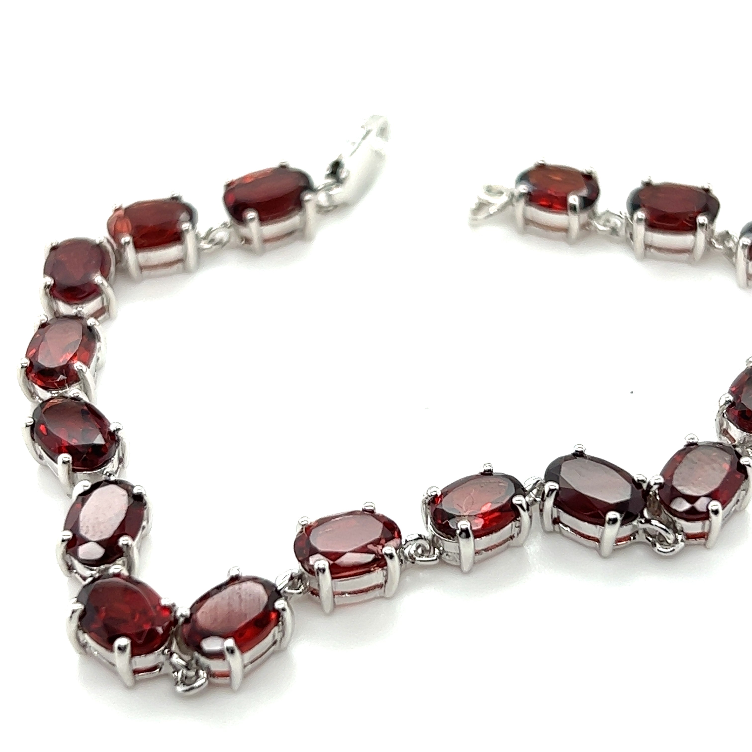 A Super Silver Pronged Garnet Bracelet With Rhodium Finish.