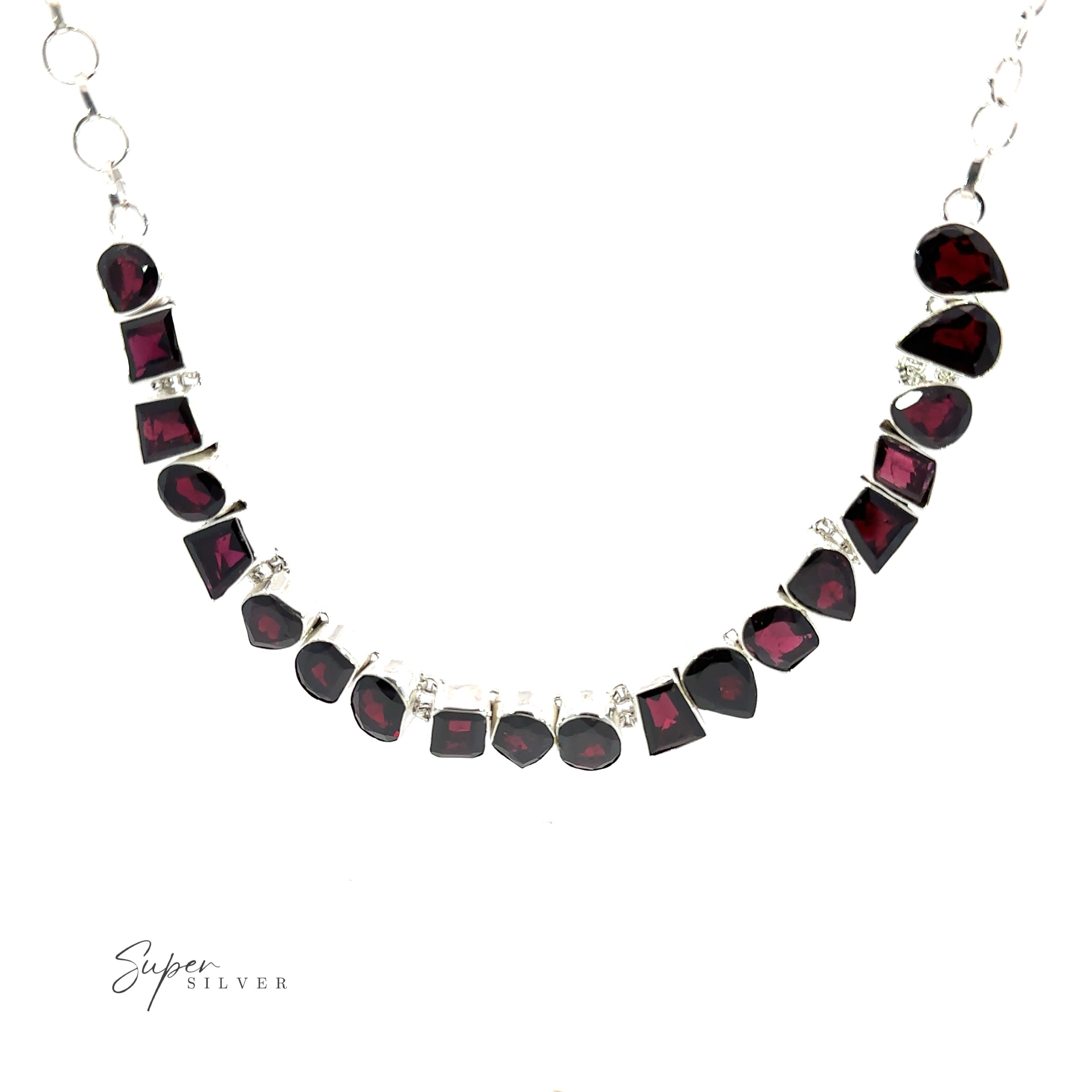 A Statement Gemstone Necklace with variously shaped red stones, including garnet, arranged in a semi-circle, is displayed against a white background. The text "Super Silver" is visible in the bottom left corner.