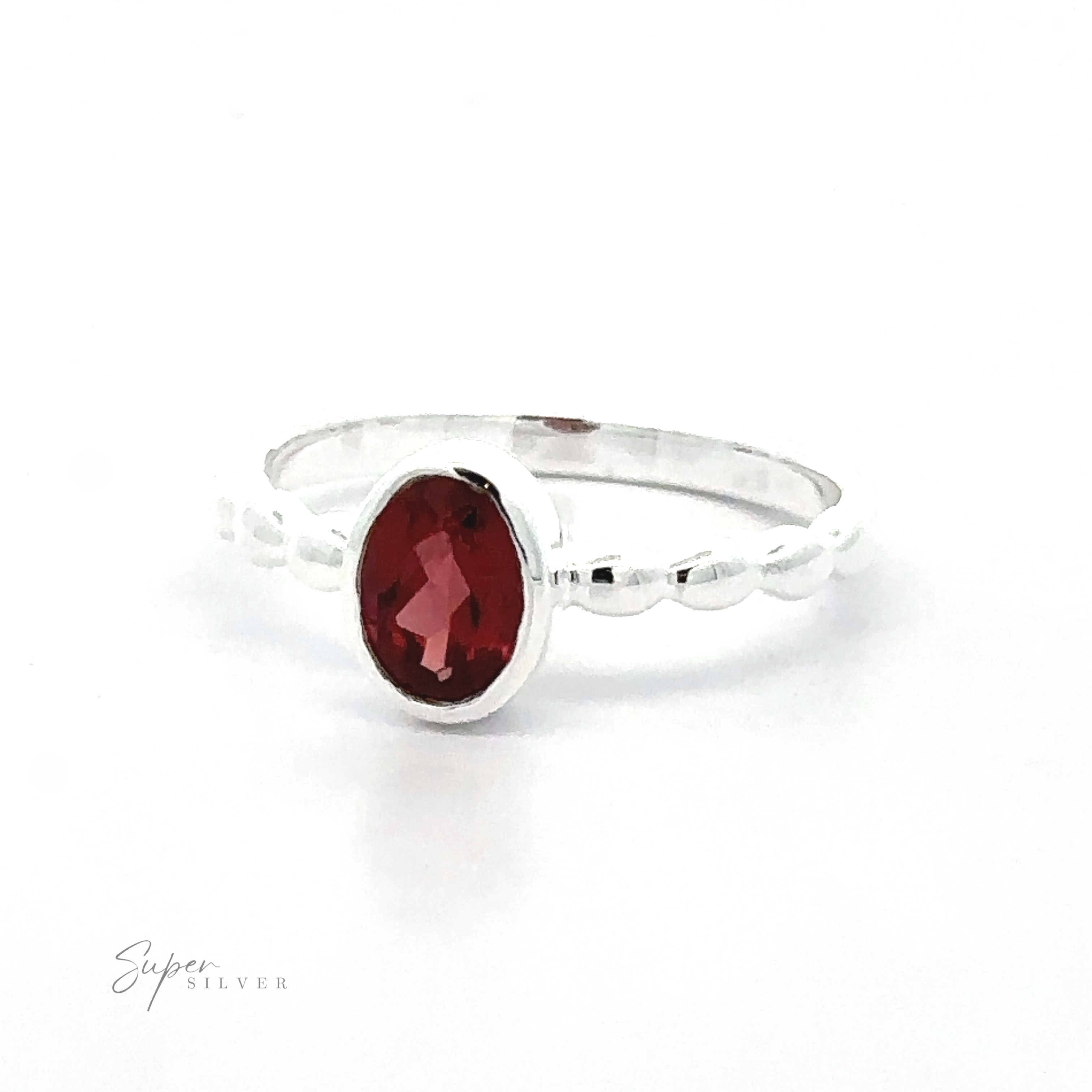 Oval Gemstone Ring with Beaded Band with a central oval red gemstone on a white background.