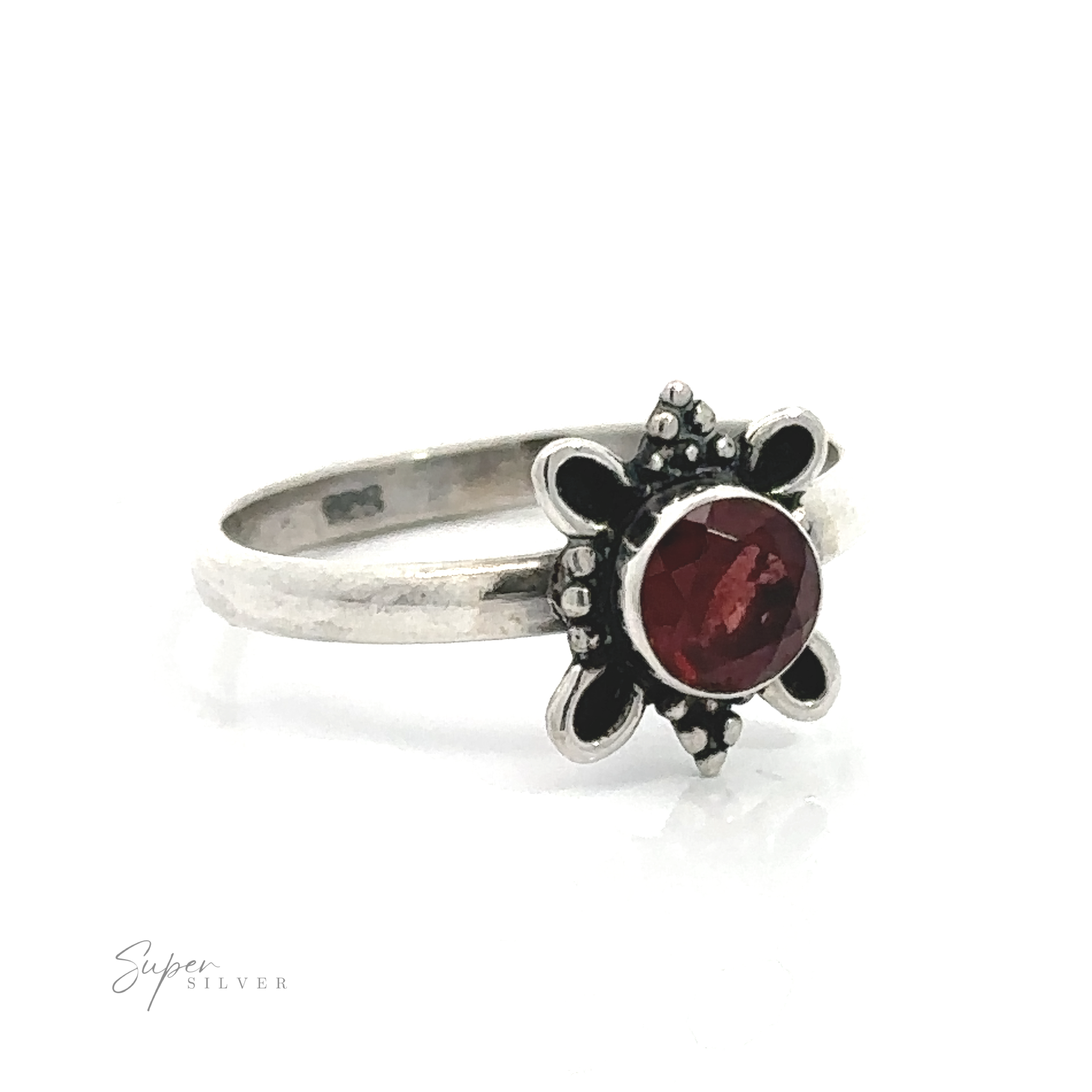 Sterling silver ring with a Round Faceted Gemstone centerpiece and ball and loop design against a white background.