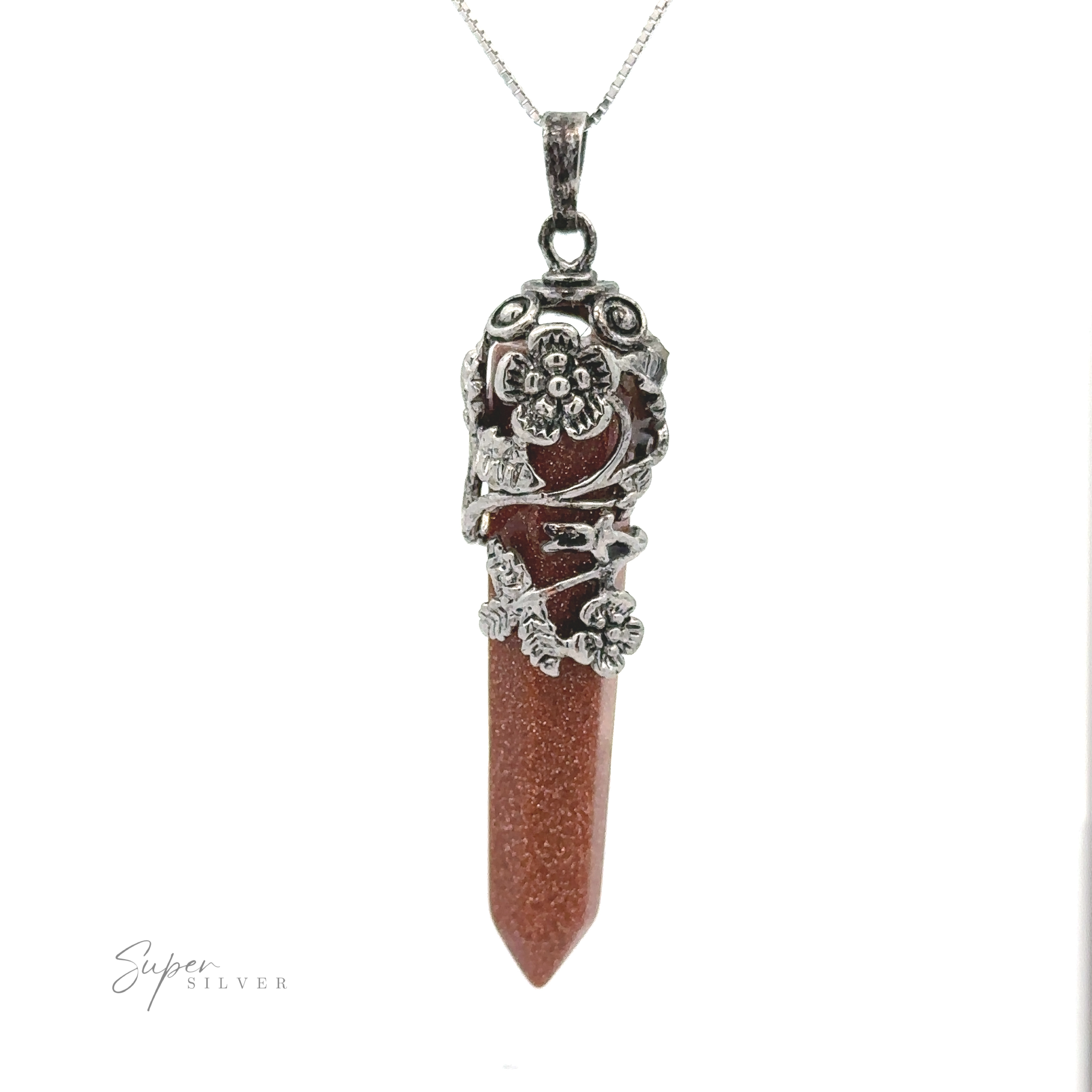Close-up of a Silver-Plated Flower Design Stone Pendant featuring an obelisk-shaped brown stone encased in intricate silver floral and leaf patterns, suspended on a silver chain against a white background.