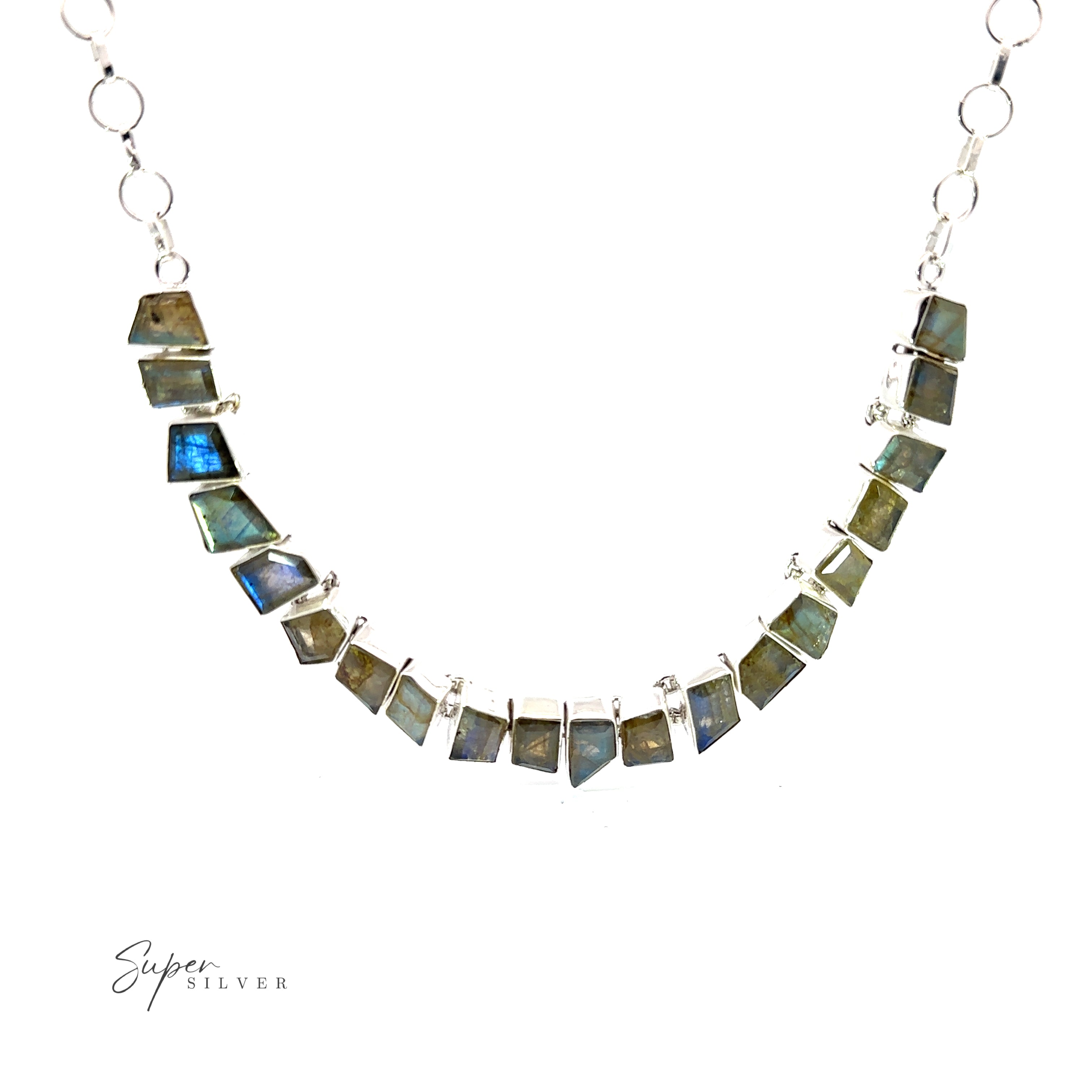 A Statement Gemstone Necklace with alternating rectangular and trapezoidal stone segments, arranged in a symmetrical pattern. The stones vary in shades of blue and green. "Super Silver" logo in the bottom left corner.