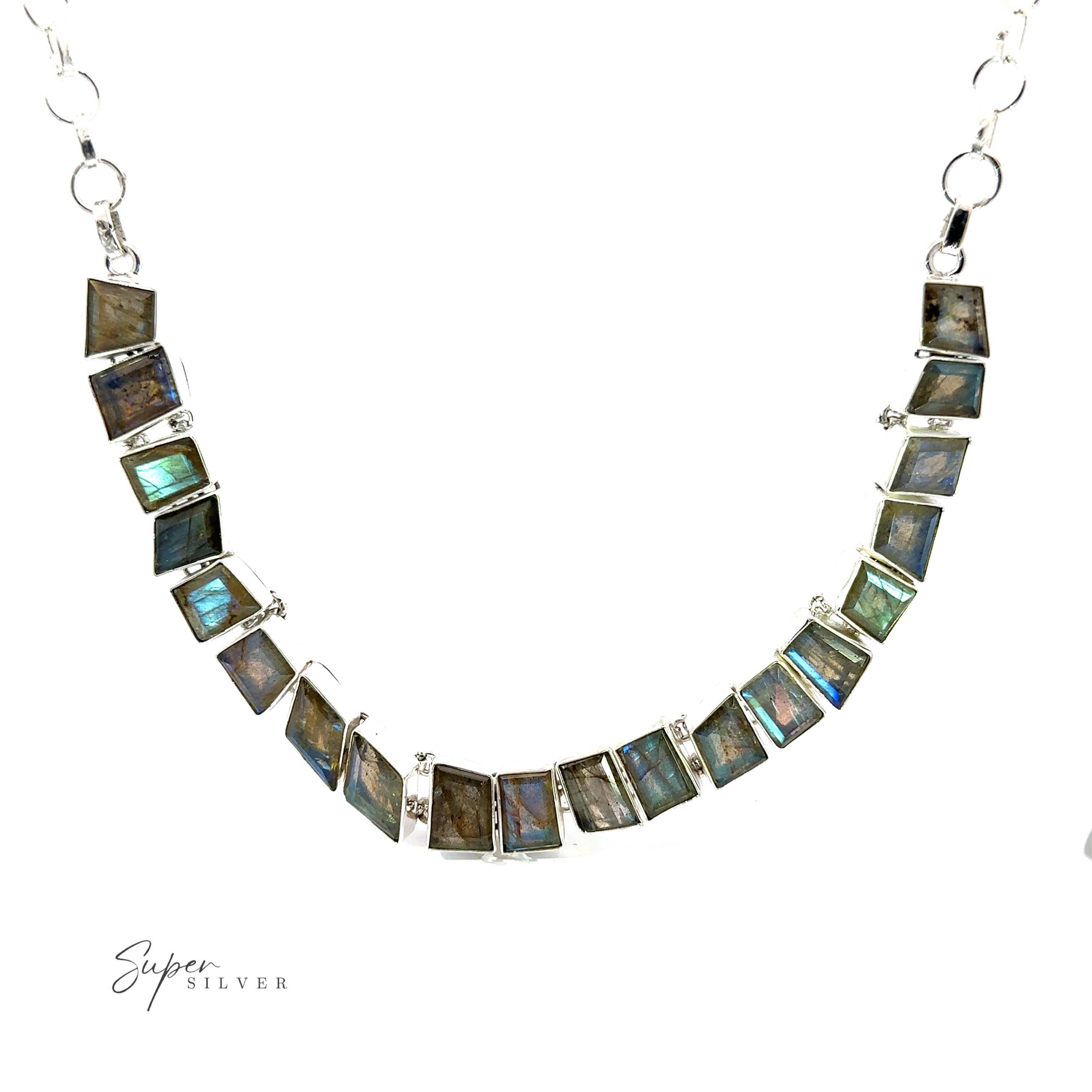 A gemstone necklace with a series of rectangular gemstones set in silver, arranged in a curved pattern. The stones feature the iridescent colors of amethyst. The chain is also silver. "Statement Gemstone Necklace" is marked in the corner.