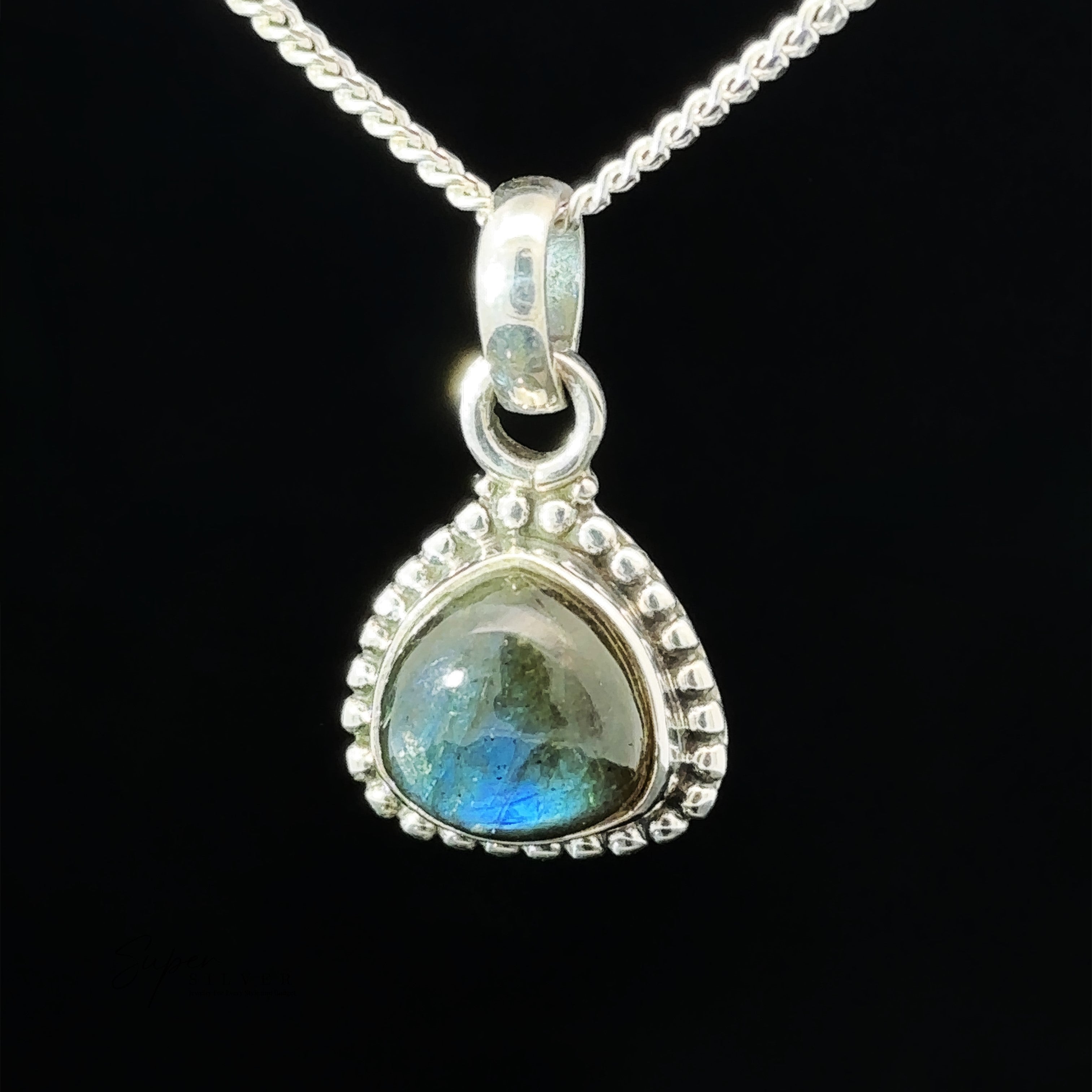 A close-up of the Beautiful Triangular Shape Stone Pendant With Beaded Design featuring a triangular-shaped labradorite stone set in a decorative sterling silver frame with an intricate beaded design.