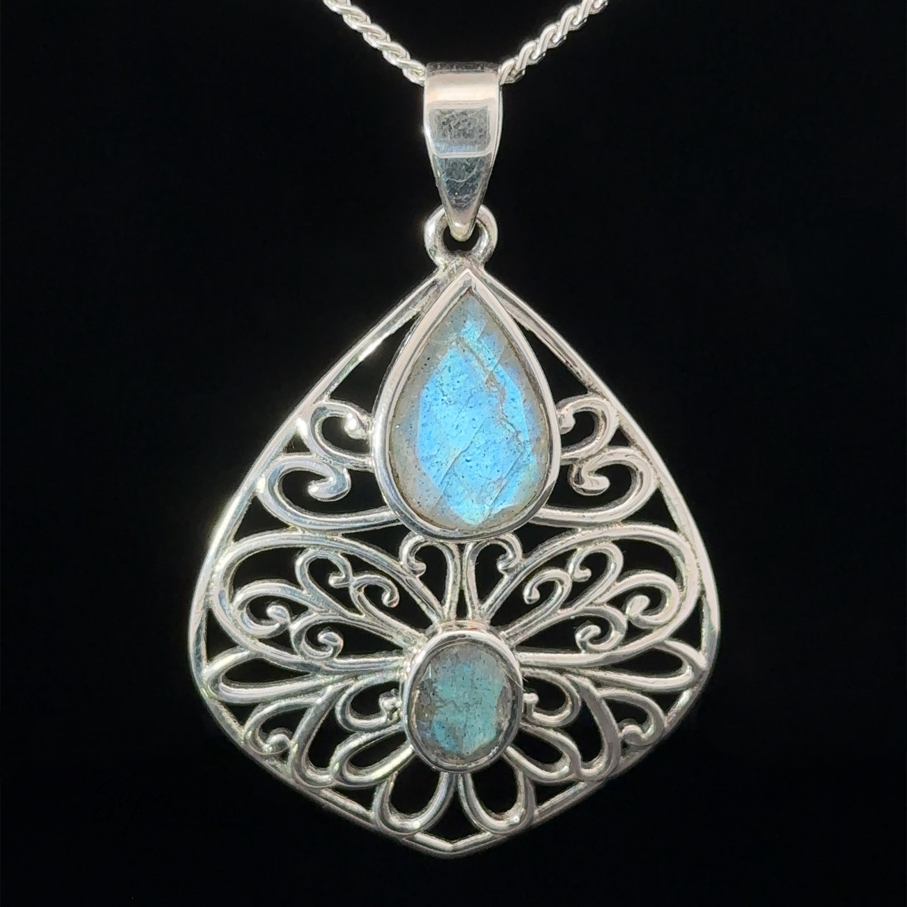 Teardrop Filigree Gemstone Pendants with an ornate sterling silver design featuring two iridescent blue stones.