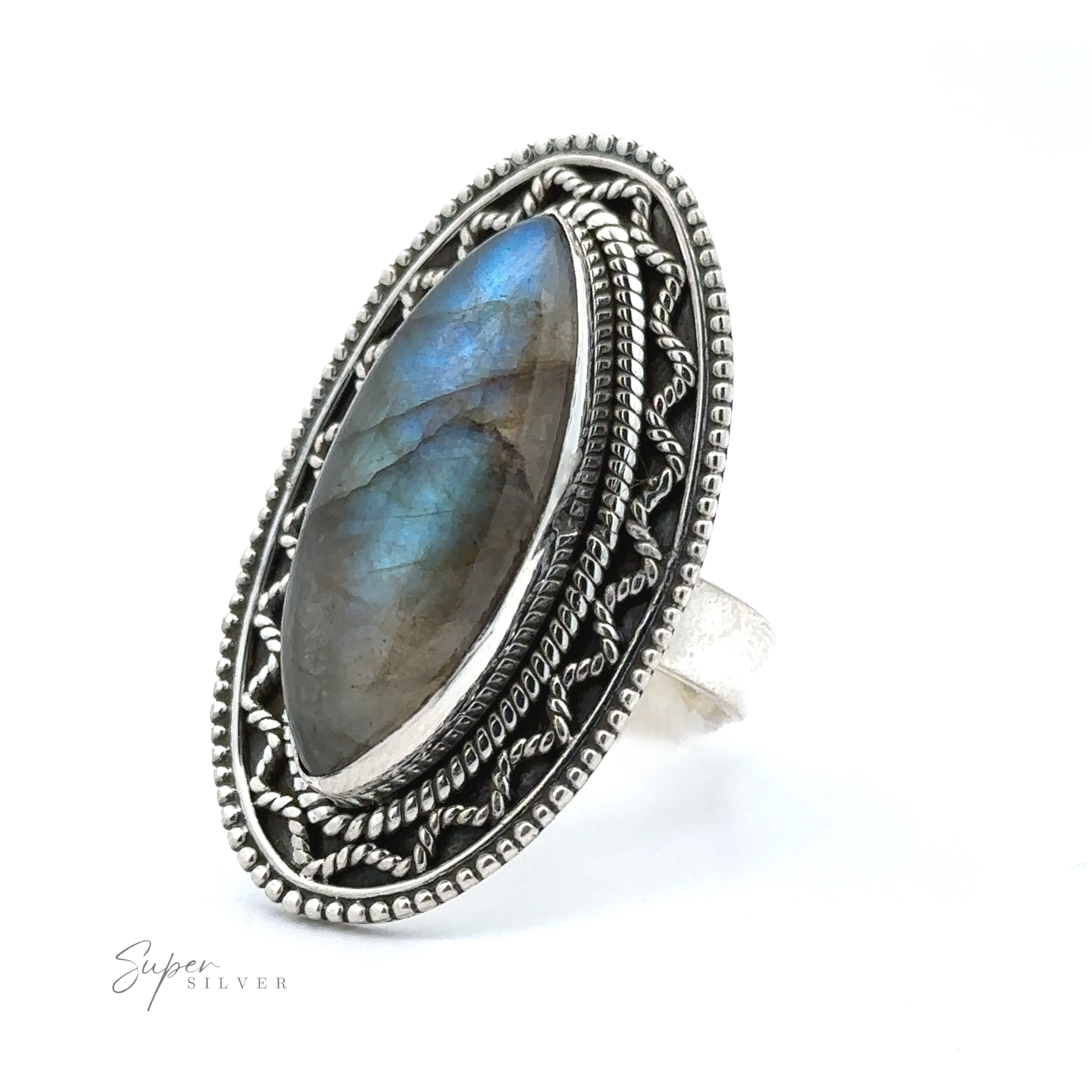 An intricately designed Marquise Shaped Gemstone Ring With Vintage Shield Border featuring an oval labradorite stone with blue and green hues, set within ornate silver detailing. With a bohemian twist and vintage appeal, this piece exudes charm. The "Super Silver" logo is visible in the bottom left corner.