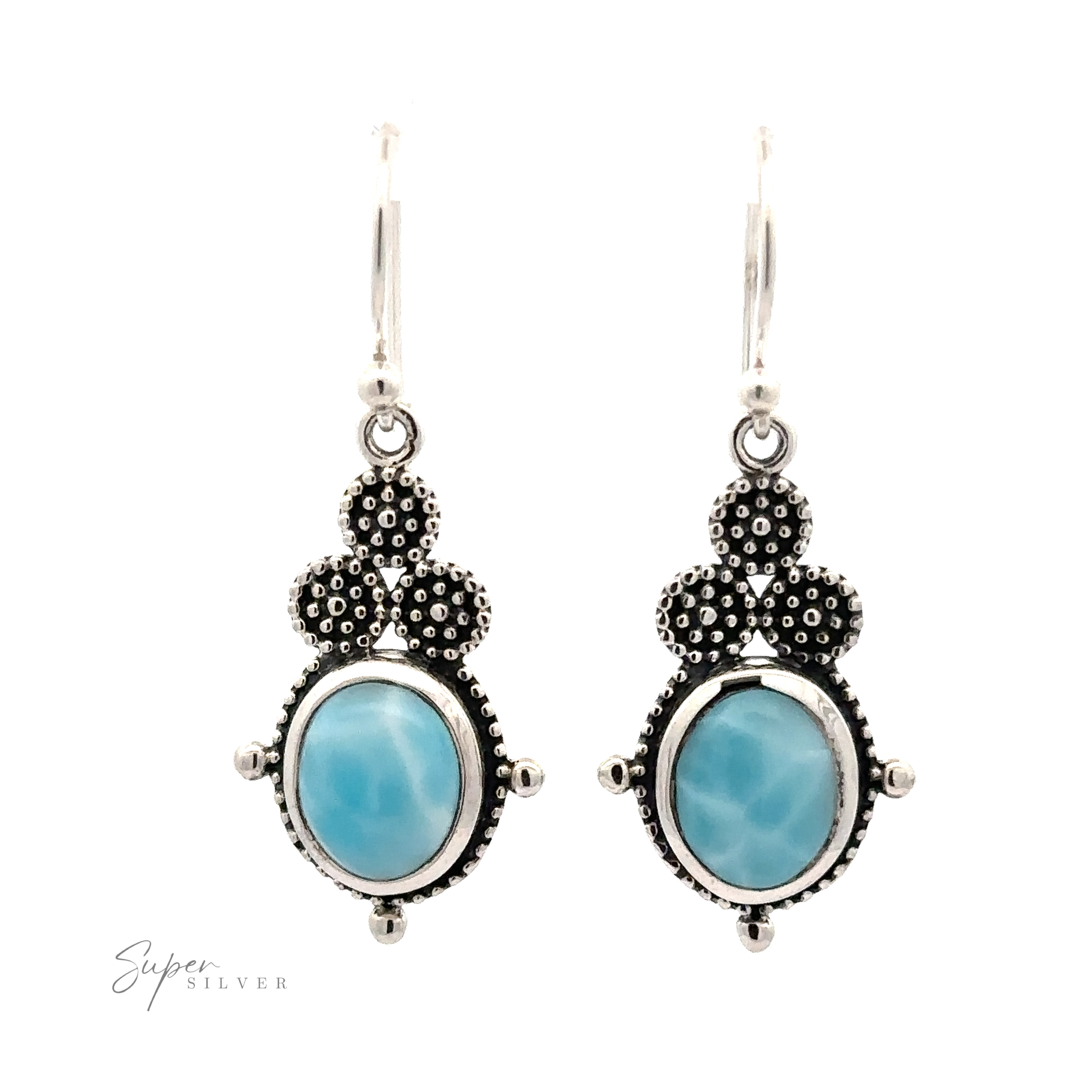 A pair of Beaded Oval Larimar Dangle Earrings with blue oval Larimar stones set in detailed sterling silver designs, featuring a small cluster of textured silver dots at the top and an inscription "Super Silver" at the bottom left.