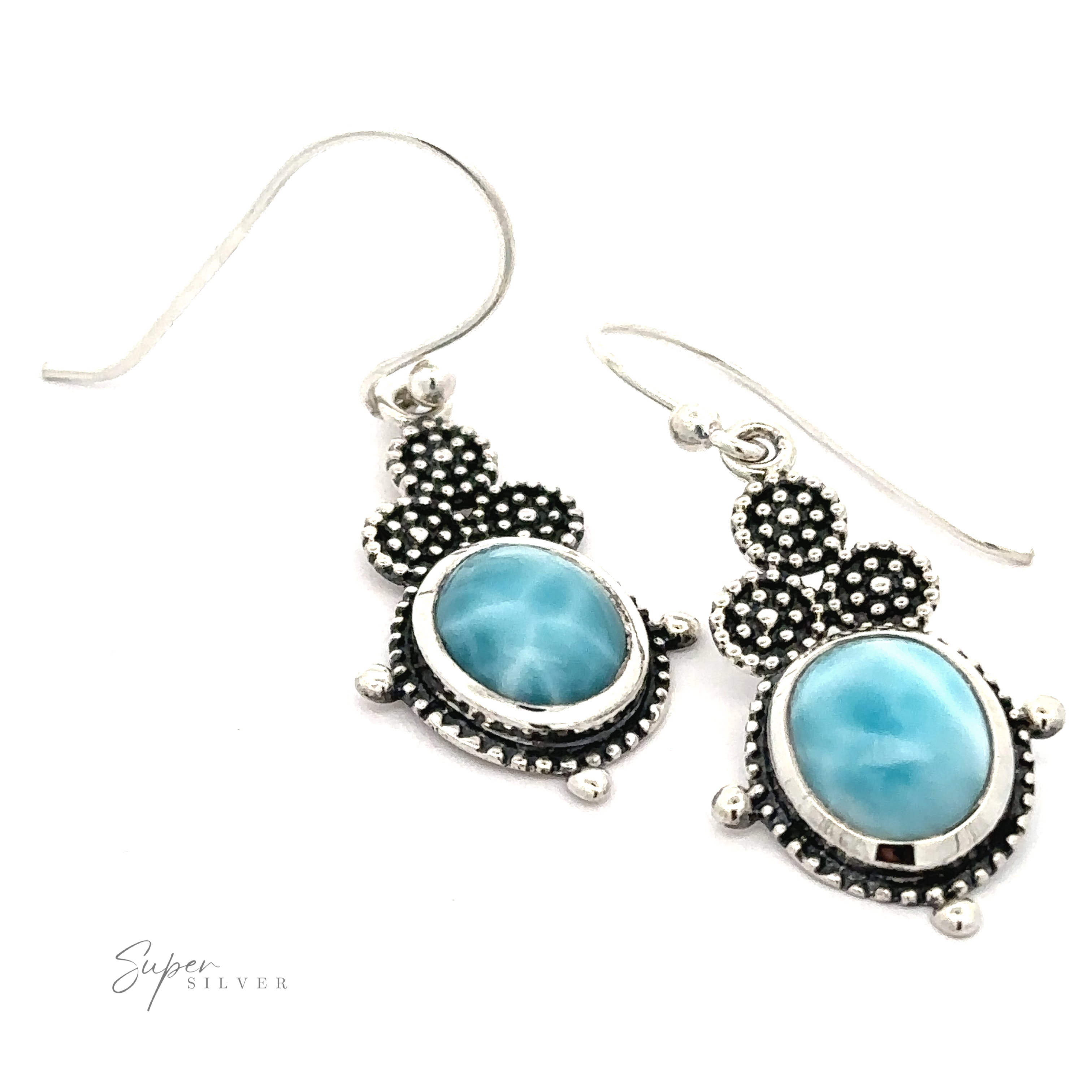 A pair of elegant Beaded Oval Larimar Dangle Earrings featuring oval blue Larimar stones with intricate beaded detailing around the gems. The hook attachments are simple and sleek. The image includes the text "Super Silver.