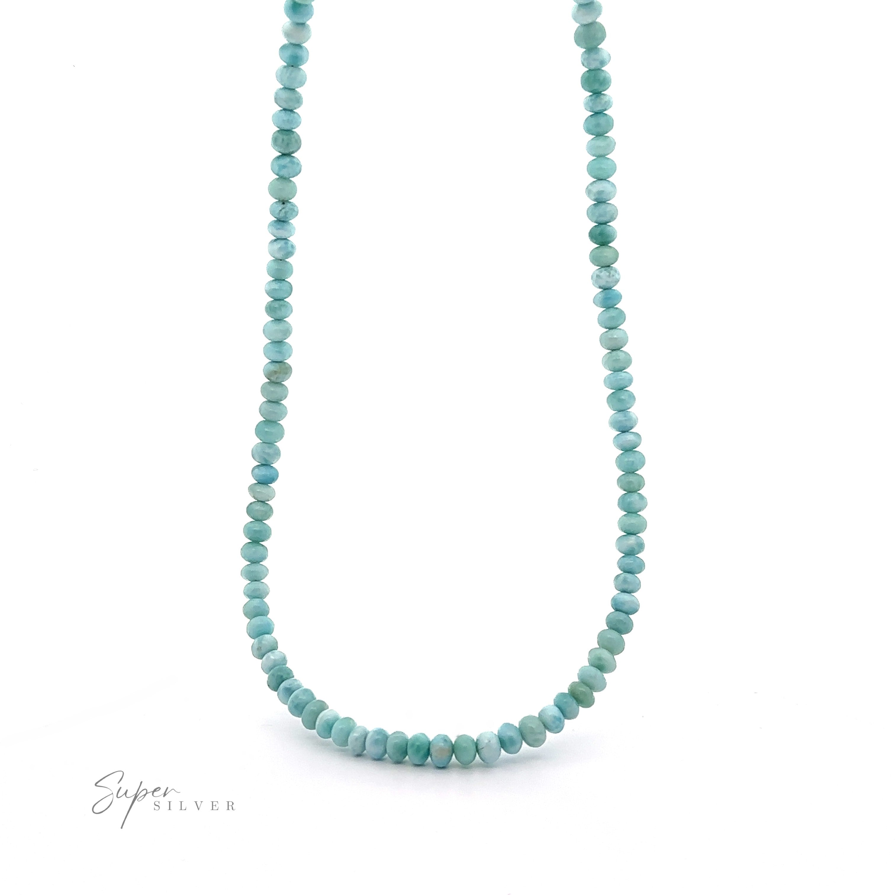 A Larimar Beaded Necklace with evenly spaced, round beads is displayed on a white backdrop. The word "Super Silver" appears in the bottom left corner, adding a touch of elegance to this Caribbean necklace.