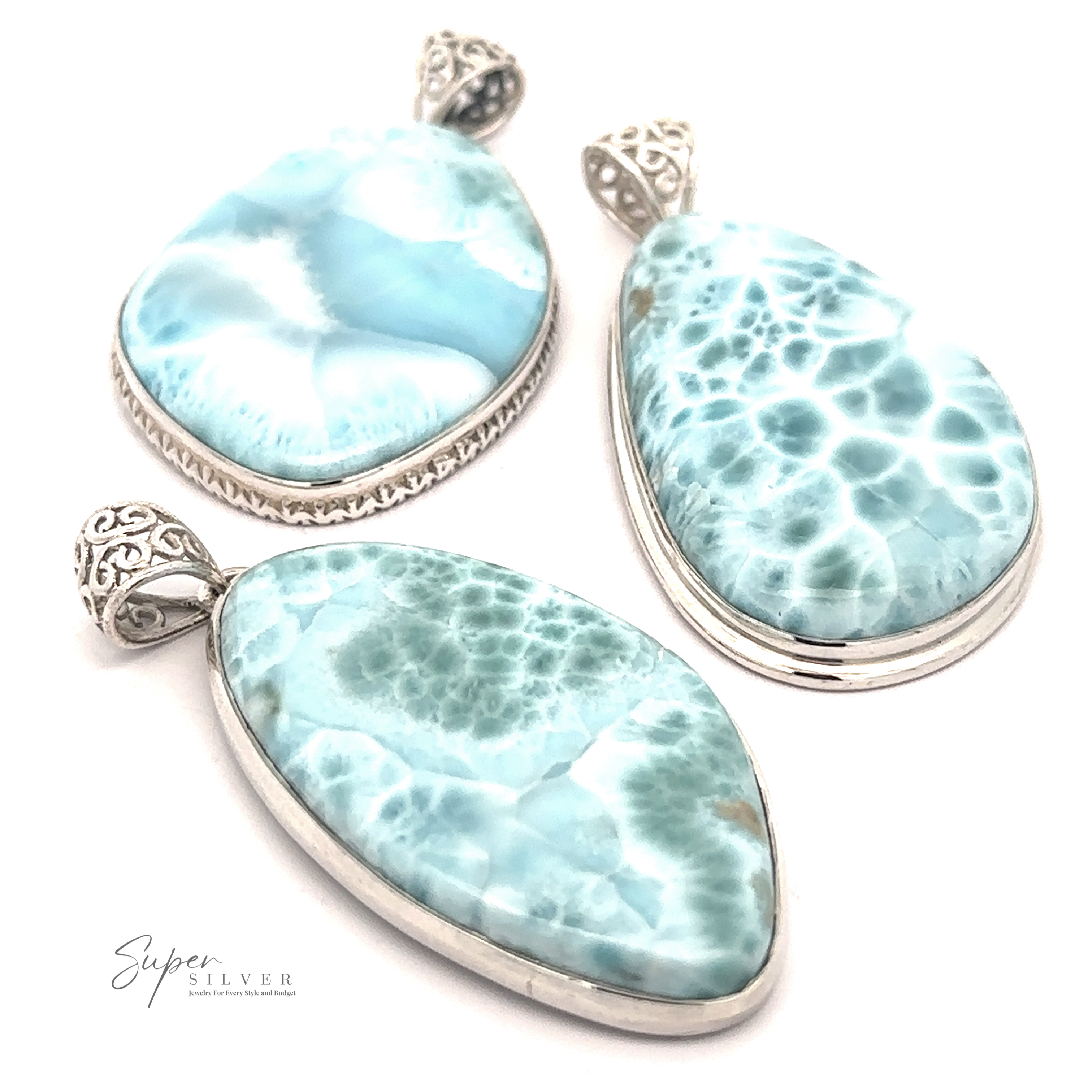Three Freeform Large Larimar Pendants with intricate sterling silver settings are displayed against a white background. The stones vary in shape, including oval, teardrop, and freeform Larimar designs.