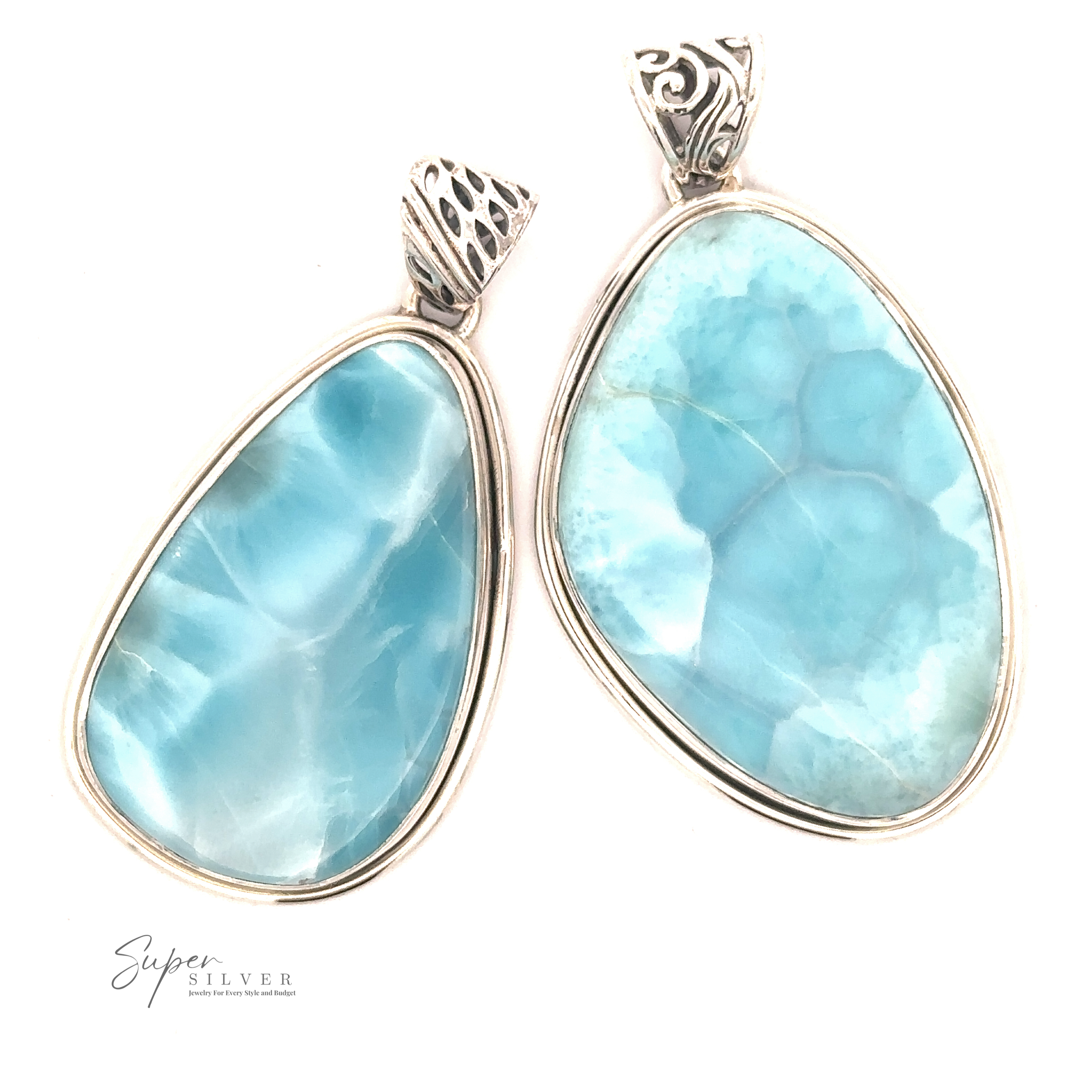 Two **Larimar Pendants with Simple Borders** on a white background. The left stone, resembling Larimar, has a lighter blue hue with white streaks, while the right stone is a solid, deeper blue.