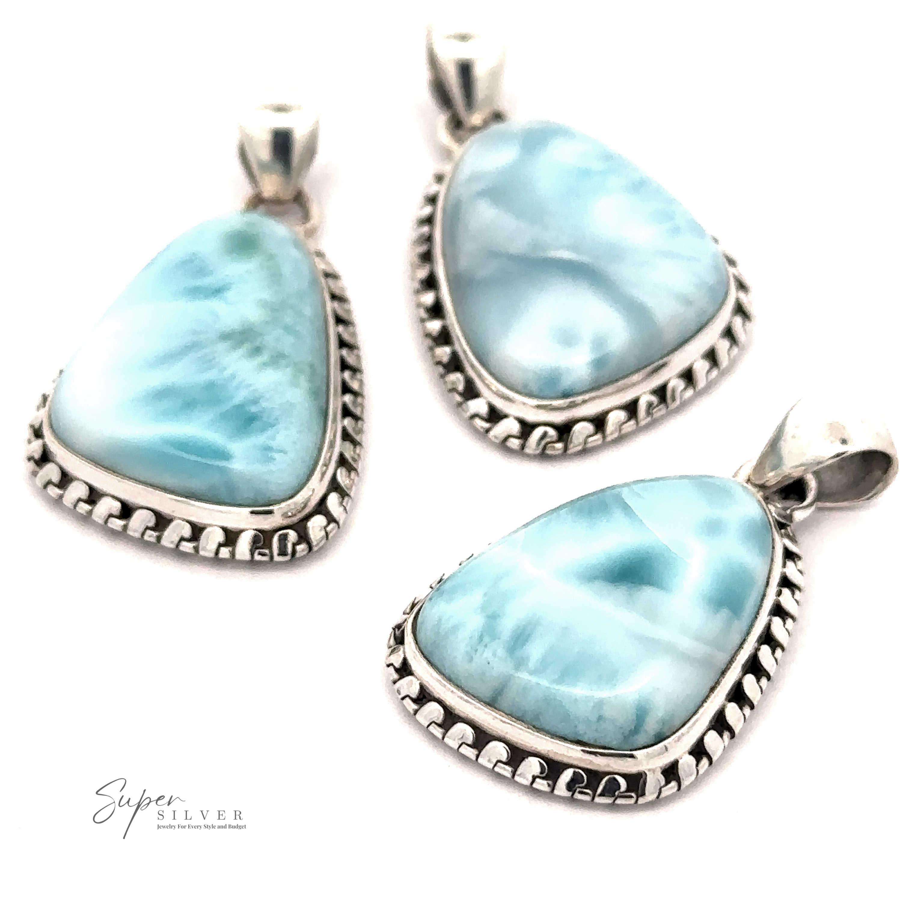 Three silver-framed, teardrop-shaped Larimar Pendants with Decorated Border featuring blue, marbled Larimar stones. The logo "Super Silver" is visible in the bottom left corner. Chain not included.