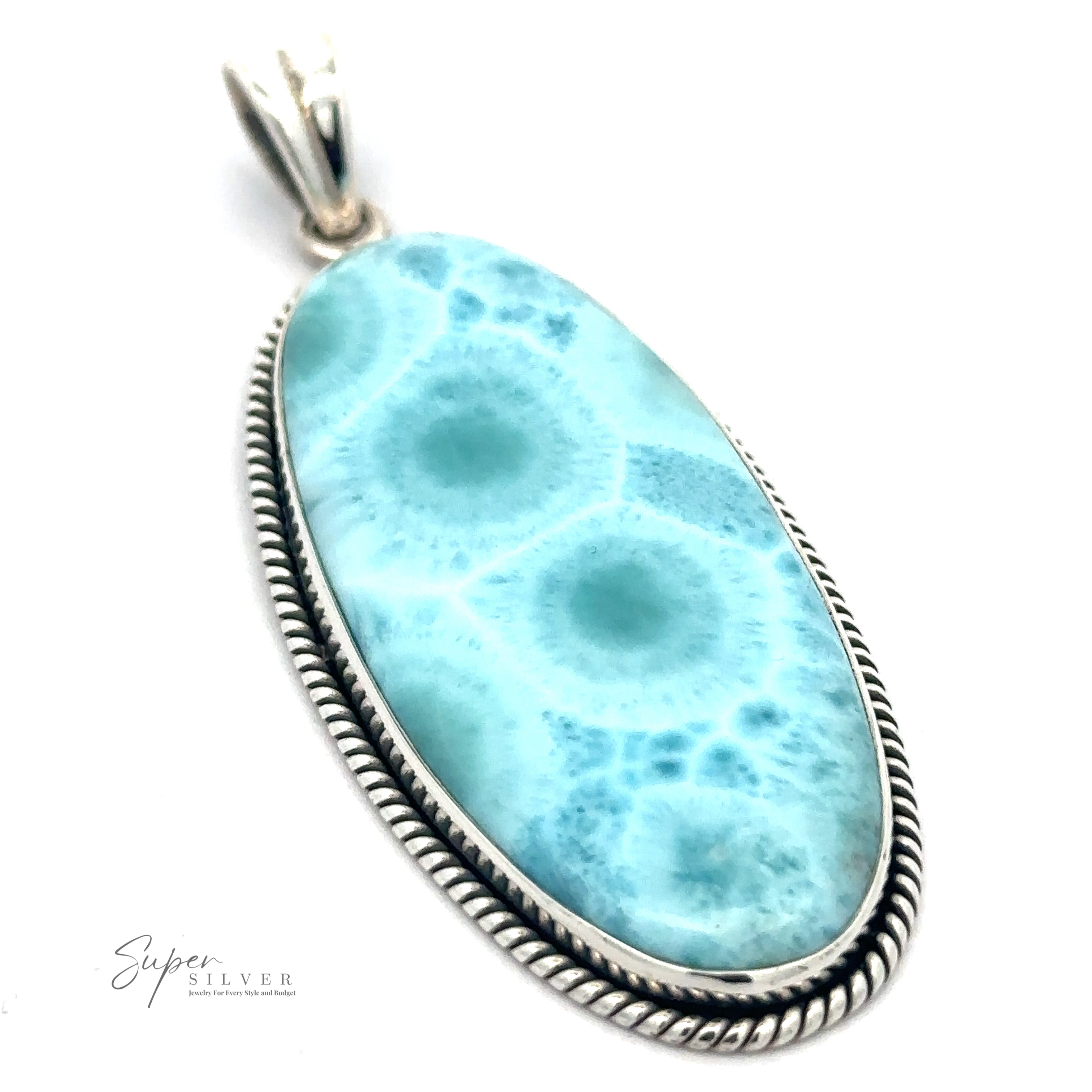 An oblong larimar pendant with rope border. The stone is predominantly light blue with white, circular patterns. Measuring 27x71mm, this piece of statement jewelry captures attention effortlessly. The photo has the text "Super Silver" in the bottom left corner.