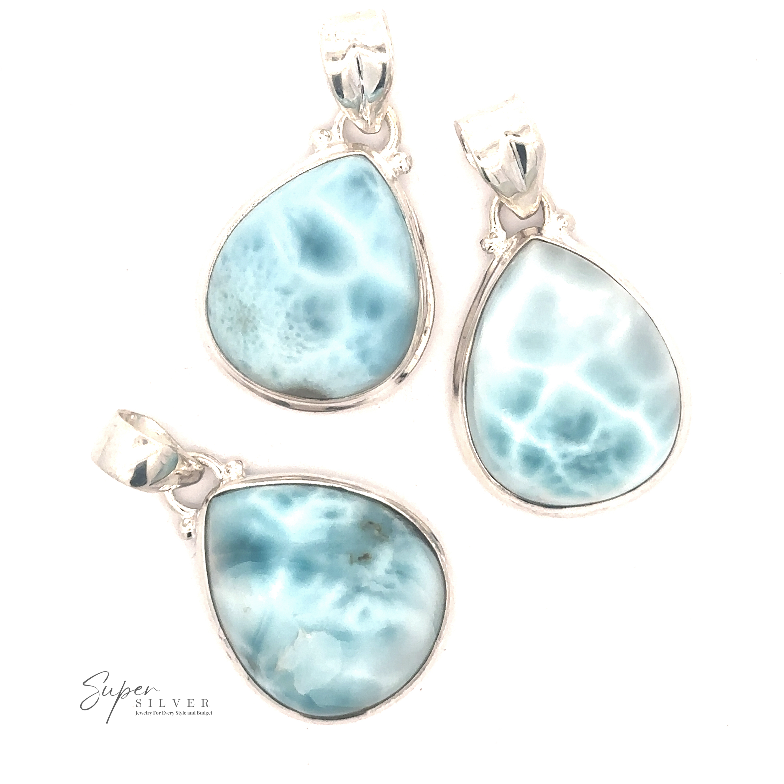 Three Small Teardrop Larimar Pendants set in sterling silver displayed on a white background. The gemstones have a cloudy pattern and varied shades of blue. "Super Silver" is written in the bottom left corner. Perfect for a night out.