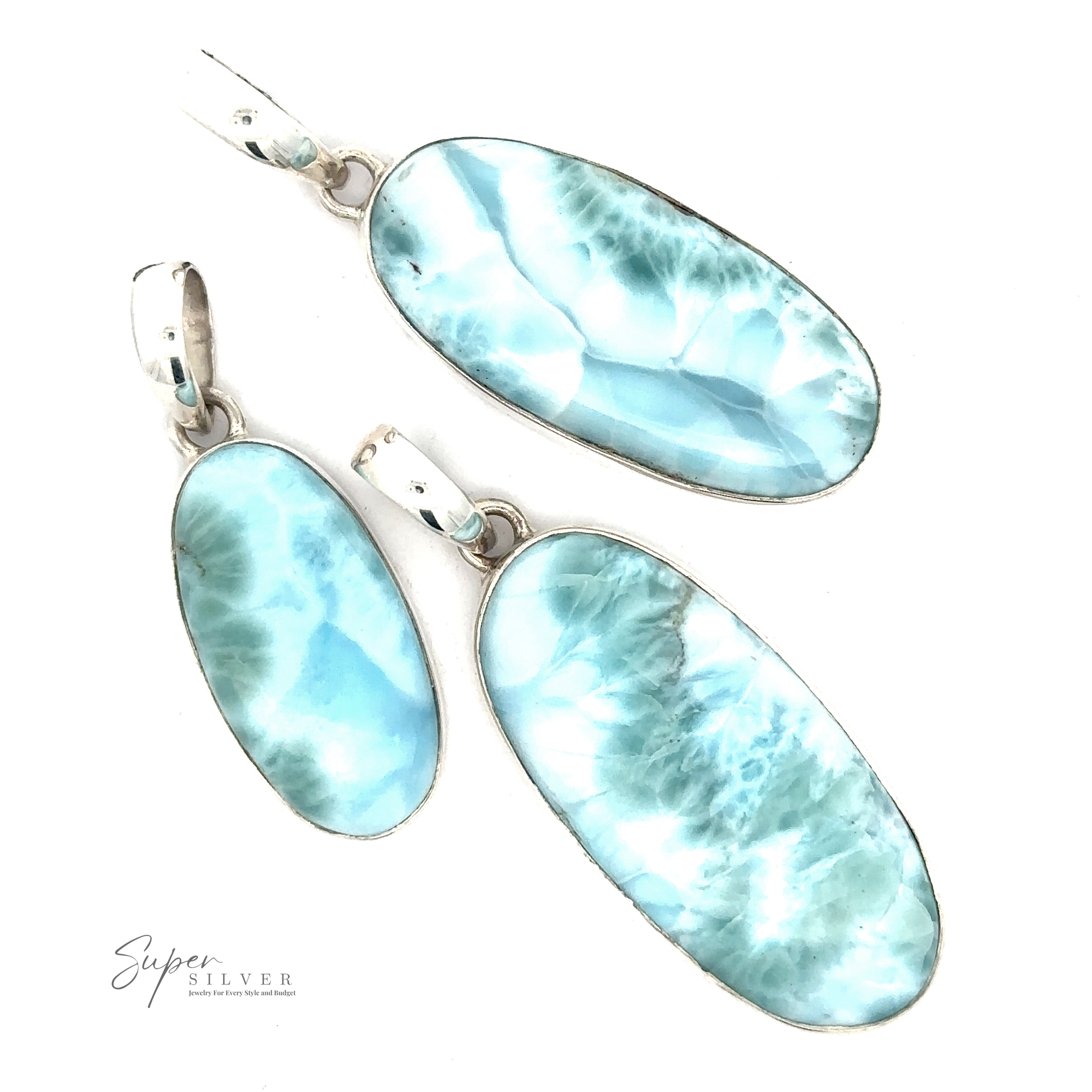 Three Beautiful Long Oval Larimar Pendants with .925 Sterling Silver settings are arranged on a white background. The pendants, featuring Larimar from the Dominican Republic, display a marbled pattern and varying shades of blue. "Super Silver" is visible in the bottom left corner.