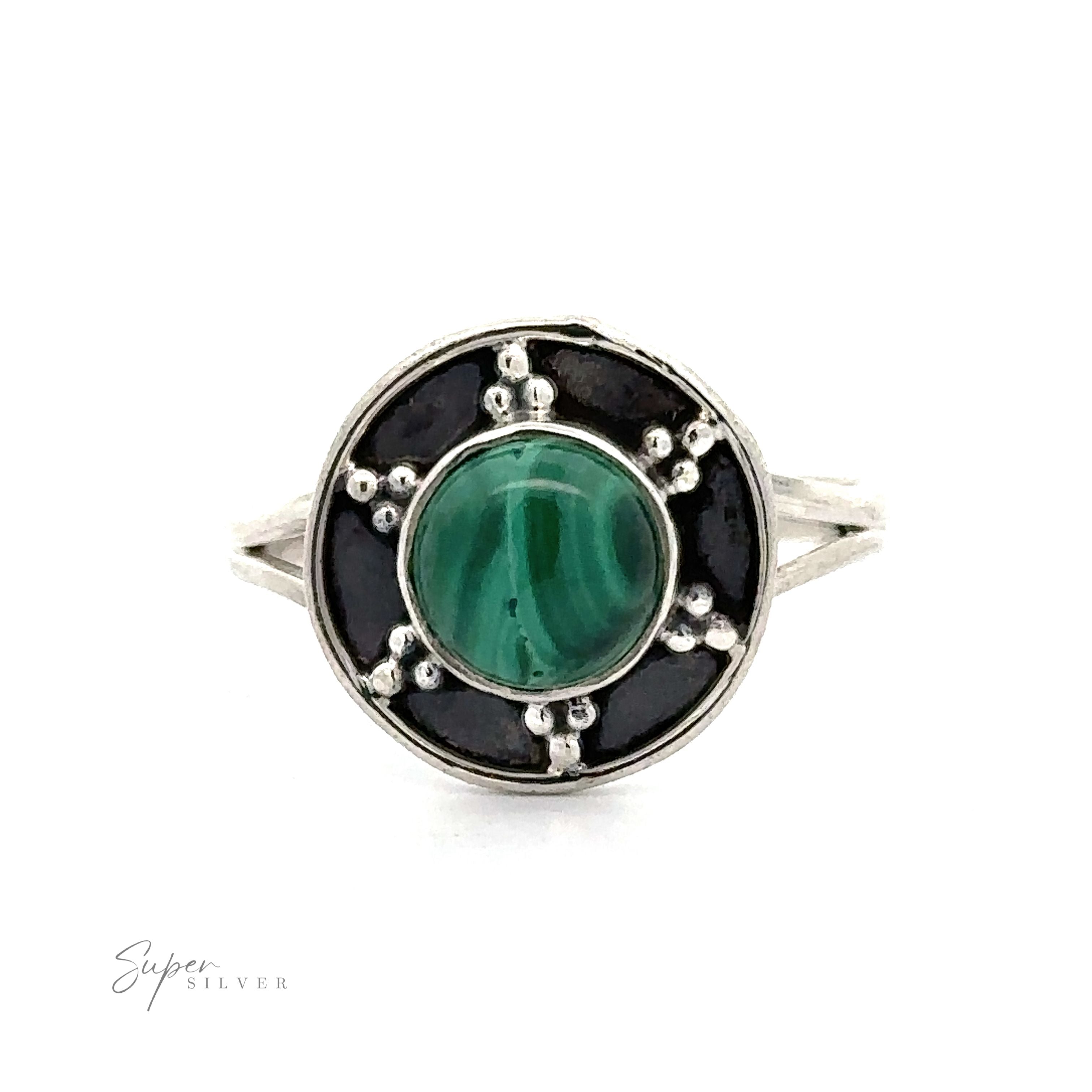 A Gemstone Ring With Unique Oxidized Design featuring a polished green stone centrally set within a circular black and oxidized silver ornate band.