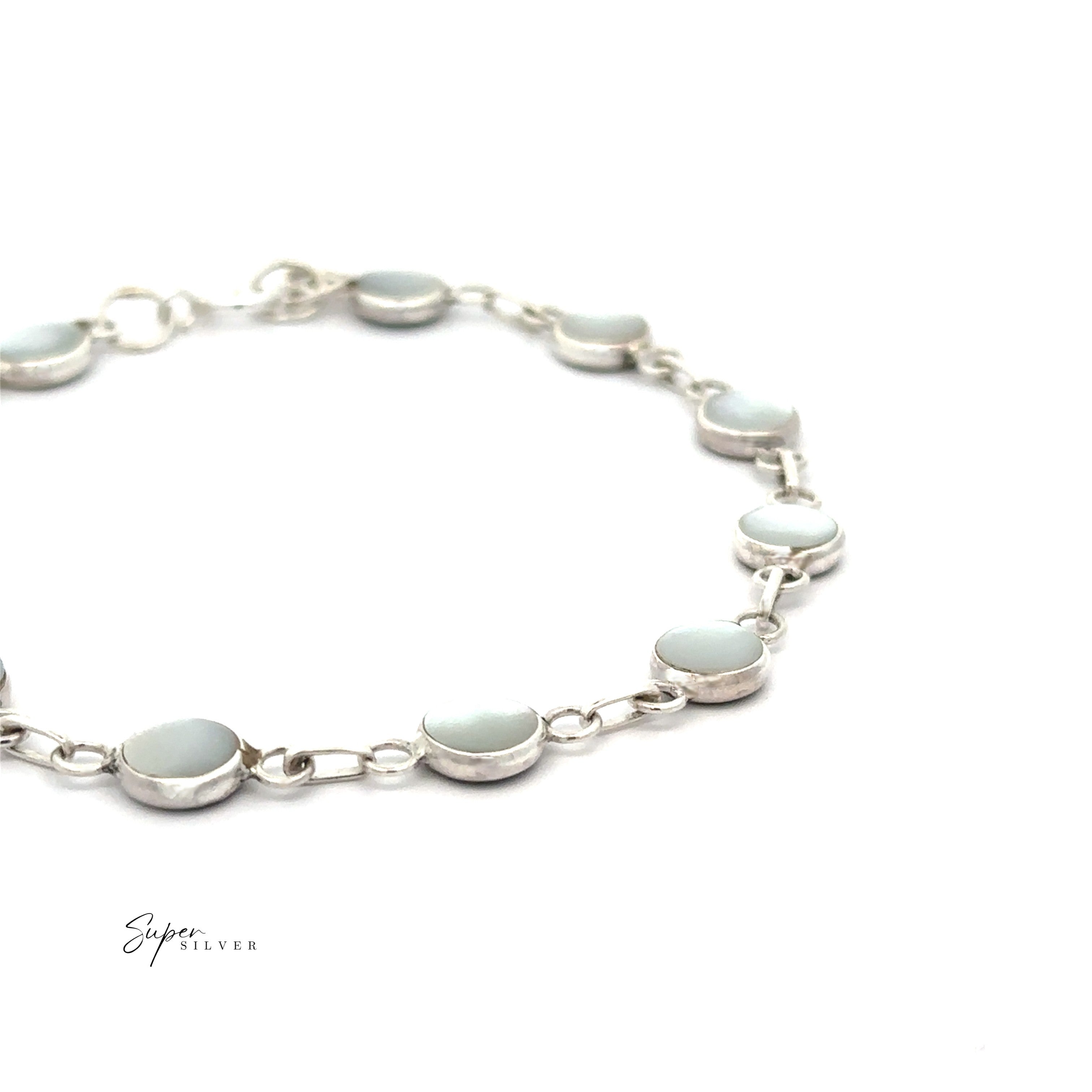 The Reversable Round Inlay Stone Bracelet features round, light blue stones set in individual bezels with small chain links and is displayed on a white background.