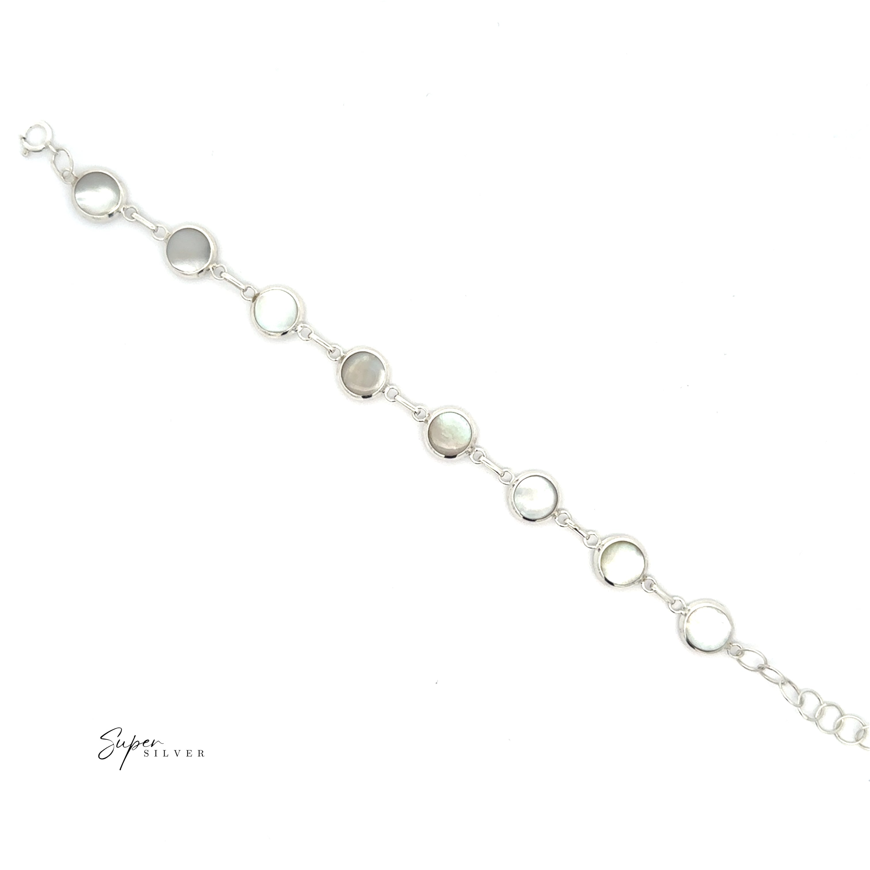 The Reversable Round Inlay Stone Bracelet features seven evenly spaced round mother-of-pearl inlays on a silver chain, offering timeless elegance and versatile style, beautifully displayed against a white background.